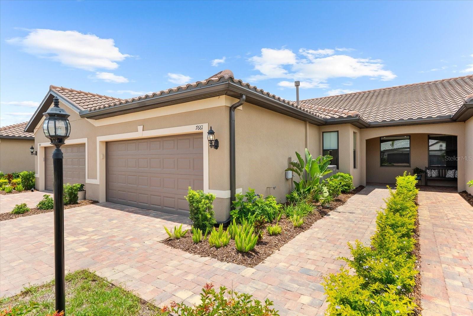One or more photo(s) has been virtually staged. Secure This Nearly New, Move-In Ready Waterfront Villa. Don’t miss this exceptional
opportunity to experience the “cruise ship” lifestyle of active adult living in Del Webb,
nestled within Lakewood Ranch—the nation’s #1 multi-generational community.
Whether you’re an investor or searching for your own slice of paradise, this Seagrove
Villa offers style, comfort, and convenience in one of the most sought-after 55+
neighborhoods. This beautifully maintained villa lives like a model home, showcasing
modern designer finishes and thoughtful upgrades throughout. Located in a 4-plex
building on a quiet street, the open-concept layout includes 2 bedrooms, 2 bathrooms, a
versatile den, and an extended screened lanai. The heart of the home—its bright, well-
appointed kitchen—features light cabinetry, a gas range, built-in microwave, and a
layout that makes entertaining effortless. The spacious gathering room flows seamlessly
into the lanai, perfect for hosting guests or enjoying peaceful evenings. You’ll find
neutral ceramic tile throughout the main living areas and den, while push carpet adds
warmth and comfort to the bedrooms. The owner’s suite is a true retreat with serene
water views and an elegant ensuite bathroom featuring dual vanities, a frameless glass
walk-in shower with ceiling height tile, and a custom walk-in closet complete with
drawers, shelving, and shoe storage. The guest bedroom is thoughtfully positioned
away from the primary suite to ensure privacy and comfort, and it too includes a custom
closet system for added convenience. The guest bath is tastefully done with ceiling
height tile in the frameless walk-in shower. High-end lighting fixtures, stylish ceiling fans,
and abundant natural light elevate the home’s bright and welcoming feel. The 2-car
garage is spotless and functional, featuring epoxy flooring, a utility sink, and modern
cabinetry with drawers and workspace. And when it’s time to relax, the extended
screened lanai awaits—offering ample room to entertain or unwind while enjoying
peaceful water views through a panoramic screen enclosure. Villas in Del Webb
Lakewood Ranch are in high demand. Act quickly to make this your own! Discover why
this vibrant, amenity-rich community is the top choice for active adult living. Schedule
your private tour today and step into the lifestyle you’ve been waiting for.