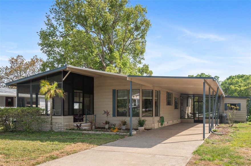 One or more of the photos are virtually staged. Price Reduced!  Whether you would enjoy spending time outside or enjoying the view of outside from the comfort of your own home, this property has it. The spacious home has fresh carpet, newer A/C and newer roof. The Open Living Room has space for the largest of TVs with plenty views outside. From the Living Room, the roof lined, screened front porch has new indoor/outdoor carpeting and enough space for a picnic table. The Kitchen eating area is very relaxing with the wrap around windows and views to outside. The Dining Room is large enough for guests and has a built in China cabinet. Not interested in entertaining, it would make a great craft or hobby area! Other features include the 37-foot carport, inside laundry, extra large closet in the primary bedroom, and outside room off the side screen porch that would make a good workshop or provide extra storage. Near the property is a hidden gem. It is a wonderful wooded area that has many walking paths with the opportunity to get out and enjoy nature. The gated, golf course community features Lake Grassmere, ponds, and swimming pools within its beautiful, rolling terrain. Quick closing.