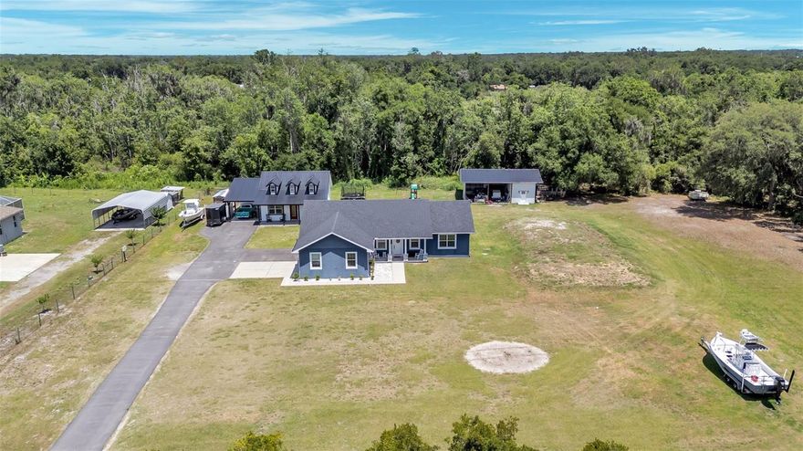 Feel, touch and fall in love this Friday between 1-4pm. Welcome to a truly one-of-a-kind custom property offering space, versatility, and endless opportunities on 2.44 acres with approximately 2 acres of dry land! The main home features a completely custom floorplan with 4 bedrooms, 2 bathrooms, and a spacious split-bedroom layout designed for both comfort and privacy. The oversized primary suite offers a ginormous walk-in closet, relaxing garden tub, and separate shower. Perfect for multi-generational living, guests, rental income, or a private retreat, the detached mother-in-law suite includes 2 bedrooms, 1.5 bathrooms and a metal roof. Need extra space for hobbies, business, storage, or entertaining? The partially enclosed pole barn is equipped with a mini-split A/C system and offers endless possibilities. Additional drainage improvements have already been added for peace of mind. Bring your toys, animals, or dreams — this unique property combines country living with flexibility and functionality all in one! Total square footage is combined.
