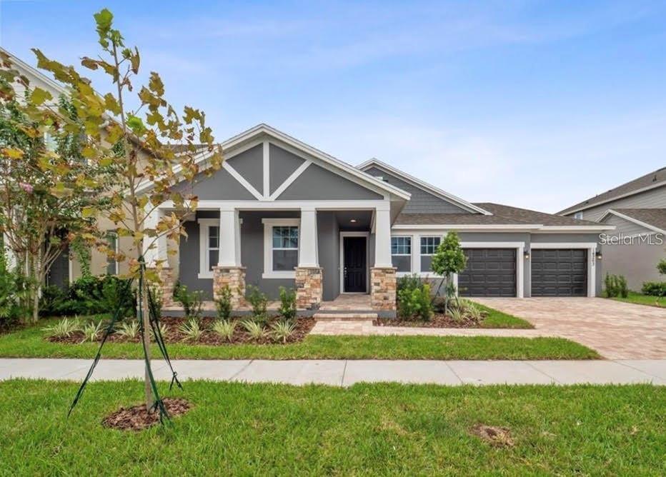 Welcome to Latham Park! Gorgeous homes located in the highly desirable Winter Garden. This 2 car garage plus storage bay home has a sunny bright, open kitchen with plenty of upgrades such as beautiful 42 inch dark Wellborn cabinets, all stainless steel Whirlpool appliances including gas range, dishwasher, and microwave plus Moen fixtures. Enormous Quartz counter-top island perfect for gatherings. Main living space and entire first floor features wood look plank flooring from Shaw and bedrooms with upgraded Shaw stain resistant carpet for comfort. Additional features include tray ceiling in the family room, optional window in powder bath, and 8' interior doors. Enjoy a swim in the Community Pool and use the community fire pit at night while viewing Fireworks. This BEAUTIFUL home is conveniently located to shopping and grocery stores. Amazing schools including brand new Castleview Elementary, Horizon West Middle and "A-rated" Windermere High School. This home utilizes energy efficient construction such as double pane Low-E vinyl windows, blower door and duct blast testing of the home, a programmable thermostat, fresh air intake, water saving plumbing fixtures, R-30 ceiling insulation, and LED lighting throughout.
