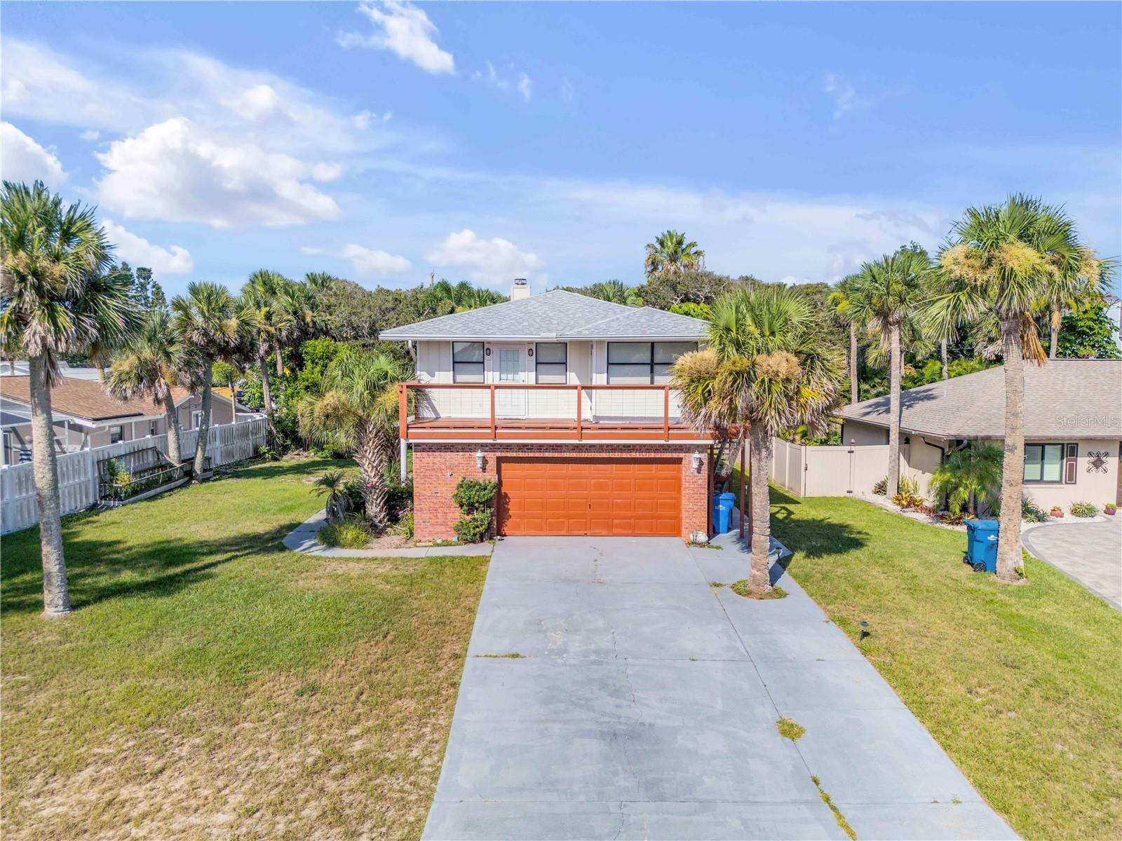 Your Beachside Retreat Awaits! Just one block from the ocean, this charming coastal home offers the perfect balance of peace and convenience. Located in the desirable Silver Sands neighborhood, the property features three bedrooms, two bathrooms, and 1,748 square feet of comfortable living space designed to fit your lifestyle — whether you're looking for a full-time residence, a vacation escape, or an income-producing property. Inside, you'll find a warm and inviting atmosphere centered around a wood-burning fireplace, ideal for cozy evenings after a day in the sun. The kitchen is outfitted with granite countertops, and natural light pours into the bathrooms thanks to thoughtfully placed skylights. A versatile layout includes a private in-law suite with its own entrance and kitchenette, offering flexibility for guests, extended family, or potential renters. Step outside to enjoy peek-a-boo ocean views from the elevated deck — a perfect spot to sip your morning coffee as the sun rises. The oversized two-car garage provides generous storage, and the 0.19-acre lot offers a semi-fenced backyard with room to create your dream outdoor oasis, whether that’s a pool, garden, or tropical retreat. Recent updates include a new roof and HVAC system in 2016, giving you added peace of mind. This home is just steps from Hiles Beach Ramp and a short 10-minute drive to Flagler Avenue, where local dining and beachside charm await. Whether you're settling in for a laid-back lifestyle or exploring a smart investment opportunity, this home in Silver Sands invites you to make it your own. Isn't it time you start "Living the Dream" in New Smyrna Beach today.....