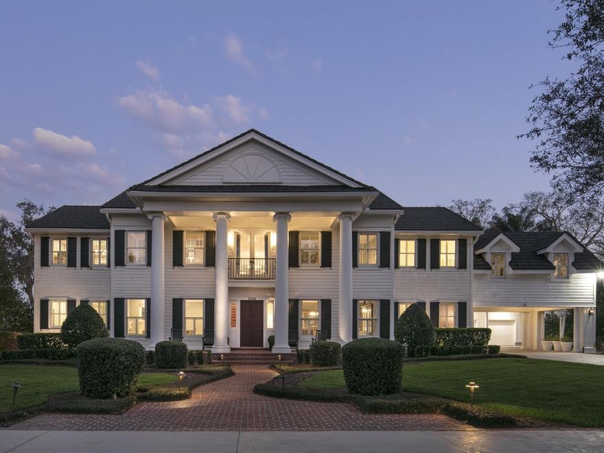 The Akers custom-built estate is a stunning property situated on over two acres of elevated land, boasting an impressive 550 feet of frontage on the renowned Butler Chain of Lakes. Nestled among mature oak trees and lush landscaping, this home offers breathtaking views of the lake. The grand entrance sets the stage for the rest of the house, featuring formal areas that have been carefully designed to maximize the scenic lake views. With real wood flooring, custom millwork, and intricate lighting, the home exudes timeless elegance.  The central gourmet kitchen is a chef's dream, equipped with custom cabinetry, stainless steel appliances, and a spacious walk-in pantry. The family room is bathed in natural light, thanks to a wall of doors and windows that provide panoramic lakefront views from every angle. The primary suite is a luxurious retreat, with French doors opening to a private balcony overlooking the lake. It also includes a private sitting area, huge walk-in closets, and a well-appointed en-suite bathroom.  The outdoor areas of the property are equally impressive. Multiple downstairs areas lead to an expansive covered porch, a sparkling pool and spa, a meticulously landscaped lawn, and a brand new two-story boat dock. The new dock features three flush-mounted lifts and a roof-top deck, perfect for enjoying the serene surroundings. Other notable features of the estate include a study, a large personal gym/bonus area, a private sand beach, and a fully equipped detached guest house.  Recent updates have further enhanced the property's appeal, including a new tile roof, an updated kitchen, a remodeled master bathroom, fresh paint inside and out, and various other upgrades.  Overall, this custom-built estate offers a combination of classic beauty, luxurious amenities, and stunning lakefront views. It provides a serene and elegant retreat in a coveted location on the Butler Chain of Lakes.