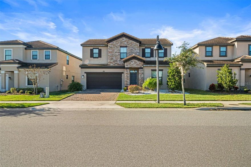 Welcome to this beautifully furnished long-term rental at 199 Macaulay’s Cove, located in the gated Balmoral community of Haines City. From the moment you enter, the home feels open, bright, and thoughtfully designed for comfortable everyday living. Large tile flooring runs throughout the main living areas, complementing the neutral palette and allowing natural light to flow easily from room to room.

The kitchen sits at the heart of the home and features a spacious island with seating, stainless steel appliances, generous cabinetry, and pendant lighting that creates a warm gathering space for meals, conversations, and daily routines. The adjacent dining area and open living room provide ample space to relax or entertain, with clear sightlines to the outdoor living area beyond the sliding glass doors.

The primary bedroom is conveniently located on the main level, offering privacy and ease of access, while the upstairs bedrooms each include their own full bathroom, creating a comfortable layout for family members, guests, or a home office arrangement. The home is fully furnished with tasteful, modern pieces that make it truly move-in ready.

Step outside to a private screened lanai featuring a sparkling pool and expansive paved deck, overlooking peaceful water views and open green space. This outdoor area feels like an extension of the living space, perfect for quiet mornings, evening relaxation, or enjoying Florida’s year-round sunshine. The pool enclosure provides both comfort and privacy while maintaining a scenic backdrop.

Residents enjoy access to Balmoral’s well-maintained amenities, including a clubhouse, fitness center, community pool, and walking paths. Conveniently located near shopping, dining, and major roadways, this home offers a balanced lifestyle of comfort, space, and accessibility. Offered fully furnished for long-term occupancy.