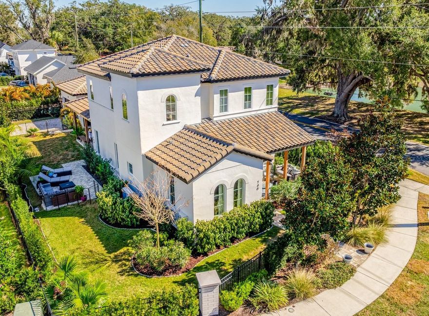 Set just a half-mile from the heart of Winter Garden, this CUSTOM BUILT 2023 showpiece delivers trail-side living, timeless design, and everyday luxury in one of the area’s most desirable communities – Garden West Terrace! Built by J&J Custom Homes, this one-of-a-kind residence sits on a .18 ACRE ~ CORNER LOT with tranquil pond views, bordering the WEST ORANGE TRAIL and located within Winter Garden’s coveted GOLF CART DISTRICT. From here, stroll or cruise to downtown shops, weekly farmers markets, dining, and entertainment – true urban convenience while maintaining a neighborhood feel. Inside, gorgeous ENGINEERED HARDWOOD floors flow throughout a thoughtfully designed layout that feels completely custom at every turn. Elevated finishes, built-ins, accent walls, upgraded fixtures, crown molding, and recessed lighting create a refined yet livable aesthetic! The OPEN LIVING AREA connects seamlessly to a MAGAZINE WORTHY KITCHEN, where timeless style meets modern performance with a Dacor 42” refrigerator, Bosch 36” professional GAS RANGE with six burners and XL oven, and generous workspace for the home chef. A formal dining room with a BUILT-IN BAR and wine fridge sets the stage for entertaining, while multiple COVERED OUTDOOR SPACES – including a covered front porch, covered side porch/lanai with stained pine ceilings, and an open paver patio – invite year-round indoor/outdoor living. The lanai is pre-plumbed for a summer kitchen with natural gas hookup, ready for your future plans! The luxurious MAIN FLOOR PRIMARY SUITE offers privacy and comfort, complete with a CUSTOM WALK-IN CLOSET and the convenience of space for a stackable washer/dryer within the suite. The additional MAIN FLOOR GUEST BEDROOM and full bath adds flexibility, while upstairs you will find the remaining bedrooms – all with walk-in closets – including a SECOND BEDROOM SUITE option, plus a full laundry room. The SPLIT BEDROOM LAYOUT is ideal for working from home, hosting guests, or growing into over time. With a TILE ROOF, fantastic CURB APPEAL, and only 11 custom homes in this small enclave located at the corner of Plant Street and Brayton Road, opportunities like this are rare. Zoned for “A-RATED” Tildenville Elementary and West Orange High School, this home checks every box – design, luxury, versatility, and an unbeatable location! Welcome to Garden West Terrace. Trail-side. Downtown-close. Custom everything. Schedule your tour today! **Seller may consider buyer concessions if made in an offer**