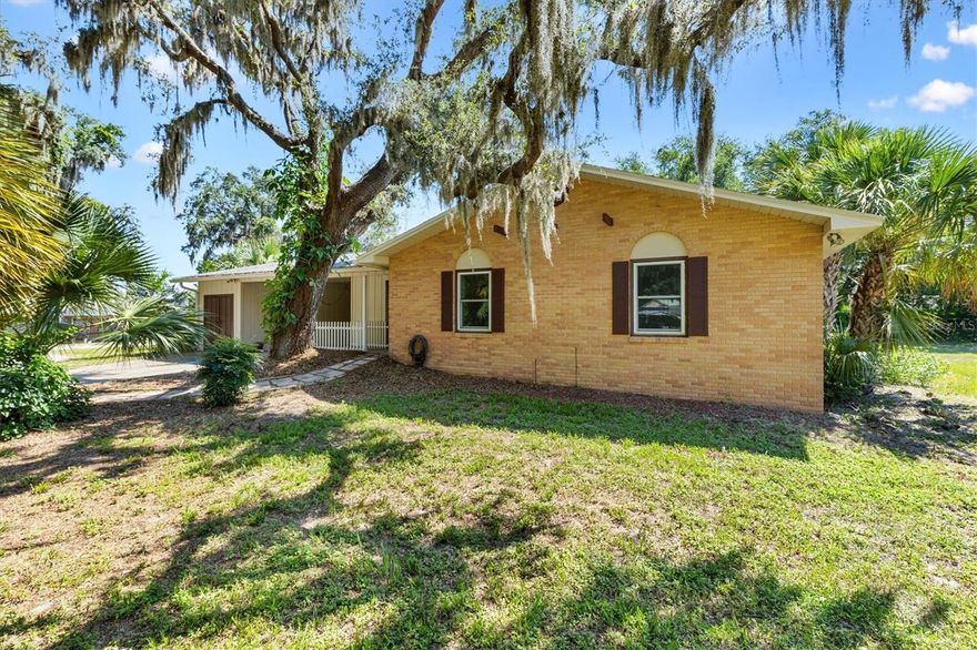 Situated on a sprawling 0.45-acre lot, this beautifully maintained 3-bedroom, 2.5-bath home combines comfort, character, and convenience. Located in the heart of Wildwood, you’ll enjoy a peaceful residential setting just minutes from shopping, dining, and The Villages. The exterior is framed by mature trees and lush landscaping, creating a serene and shaded retreat. Step inside to a bright, open living area filled with natural light and accented by gorgeous flooring. The updated kitchen showcases crisp white cabinetry, modern appliances, and a striking tile backsplash. The spacious master suite offers a private escape with an ensuite featuring a custom-tiled shower. Generously sized guest bedrooms share a well-appointed hall bath, making this home ideal for family or visitors. The enclosed porch, lined with glass windows, adds versatile living space perfect for relaxing or entertaining year-round. Outdoors, the expansive yard provides endless possibilities—from gardening and recreation to potential future additions. With its functional layout, multiple living spaces, and prime location, this home delivers both comfort and opportunity. So don't wait and call today for your private showing!