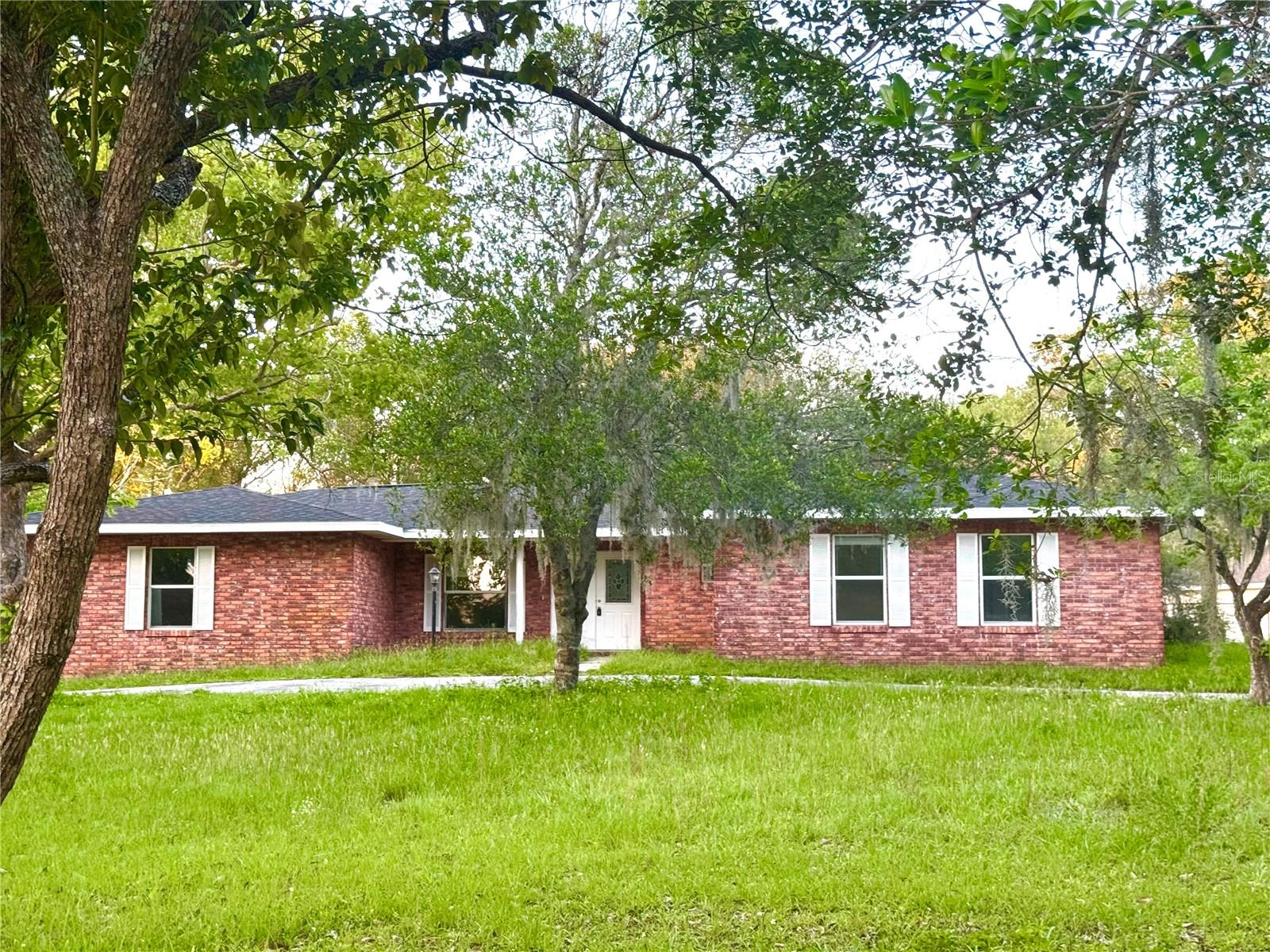 One or more photo(s) has been virtually staged. The process of bringing this home back to life has begun! This brick home could be one to be proud of. There's plenty of room for everyone with 4 bedrooms and 2 baths inside, and the outside has 1.21 acres of open space on a wonderfully placed corner parcel. Oversized widows let in so much natural light and there are so many living spaces for enjoy. NEW ROOF 2025! New flooring throughout and fresh paint on the walls make the inviting open space seem even more open. Located in Countryside Estates, a community that has no HOA, but is well kept with half acre and acre homesites. The location is amazing, situated a couple of miles from downtown Inverness with amazing entertainment, restaurants and shops, and outdoor recreation. In the other direction is the shopping area to meet all your retail needs. Just around the corner is access to access to the Citrus Wildlife Management section of the 157 thousand acre Withlacoochee State Forest, the third largest state forest in Florida!