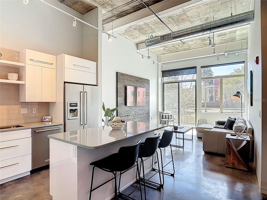 Step into downtown Ocala living at 302 Broadway — a thoughtfully converted, fully furnished 2BR/1BA loft that blends industrial character with modern comfort. Polished concrete floors and an open island kitchen with stainless appliances create a dramatic, low-maintenance interior; a private balcony and shared rooftop terrace expand your entertaining space. Two assigned parking spaces and in-unit laundry add everyday convenience. Association documents, conversion engineering and termite reports are available; buyers should confirm current HOA assessments and leasing policy with Vine Property Management.