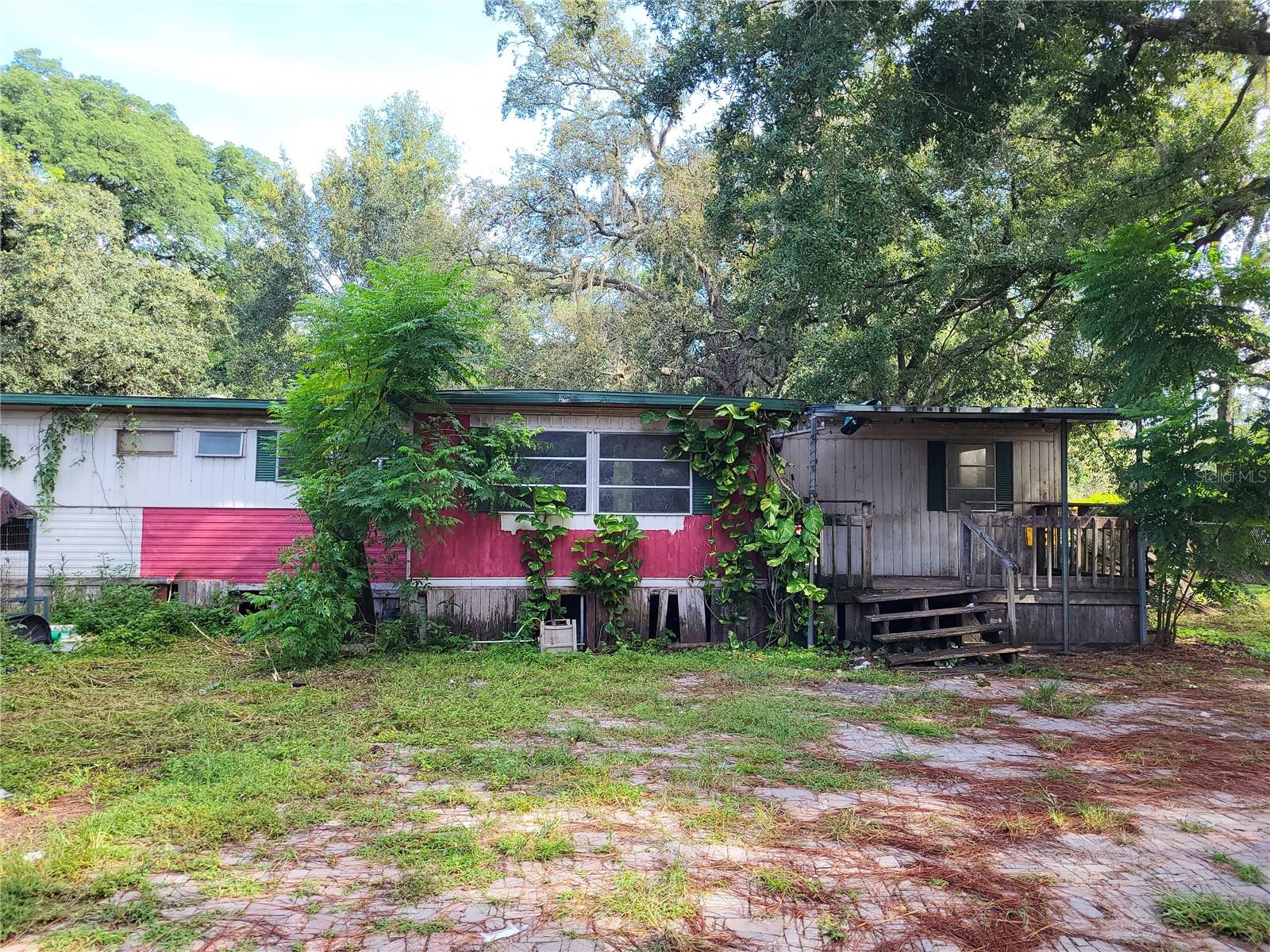 Great opportunity to own an acre of land within AR zoning. Home needs rehab, but property has amazing potential!! Fully wire-fenced, huge metal garage with electric, Horse barn with 3 stalls, chicken shed too! Electric service and septic in place, new well to be installed by seller prior to closing. 135' frontage (appx) on Pinto, and 330' deep (appx). If you choose not to rehab the home, it's easy to replace or build since impact fees are mitigated because of the current dwelling.
