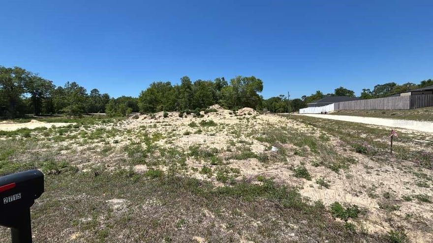 Vacant lot in growing Rainbow Park just minutes from World Equestrian Center.  Lot is cleared and ready to build. No need to drive through blocks and blocks of dirt roads.  This parcel is perfectly situated just 2 short blocks from the main paved road 140 Avenue.  Survey is included.
