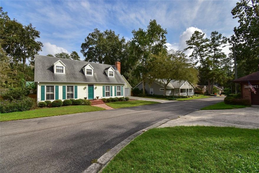 Welcome to this picture-perfect storybook home, New Roof, beautifully constructed by Tom Spain and conveniently located just minutes from UF, Oaks Mall, I-75, and a variety of restaurants and shopping options. As you enter the home, you are greeted by a welcoming foyer that opens to a spacious formal living room, which seamlessly flows into a large formal dining room. Both rooms are adorned with luxury vinyl plank (LVP) flooring and feature floor-to-ceiling windows offering picturesque views of the backyard. The kitchen is a chef's delight, boasting stainless steel appliances, Spanish tile flooring, ample counter space, and numerous cabinets for storage. The adjacent dining area is bright and airy, with windows and a French door leading to the screened porch. This home is perfect for entertaining, with a very large family room featuring LVP floors, a cozy fireplace, and a wall of French doors that open to the serene screened porch. Upstairs, you will find two generously sized guest rooms, a hall bath, and an oversized primary suite with a spacious bath. The lovely backyard offers a spacious courtyard area, a sprawling yard ideal for various activities, and a convenient storage shed tucked away in the corner. New roof is being istalled.