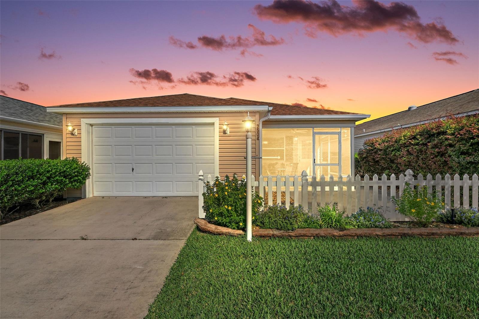 CHARMING TURNKEY with GOLF CART 2/2 COLONY Patio Villa, NEW ROOF (2025), REAR PRIVACY FENCE, and PAID BOND in the sought-after VILLAGE OF HEMINGWAY – just minutes from Lake Sumter Landing and Brownwood Paddock Square! From the moment you arrive, you’ll be greeted by a classic white picket fence, lush mature landscaping, and a welcoming screened front porch that set the tone for this delightful villa. Step inside to discover an inviting open floor plan filled with natural light, where a solar tube illuminates the space and a mirrored dining wall adds both elegance and depth. The home’s luxury vinyl plank flooring flows seamlessly throughout most of the living areas—completely carpet-free for easy maintenance and modern appeal! The kitchen offers both charm and functionality with its bright white double sink, pantry, and eat-in bar, making it the perfect spot for casual meals or entertaining. Just beyond, sliding glass doors open to your private, fenced backyard retreat, where you can savor your morning coffee, host evening gatherings, or simply enjoy the Florida sunshine in peace. The spacious primary suite is a true retreat, featuring a walk-in closet and en-suite bath with a walk-in shower. A comfortable guest bedroom and nearby full bath with a tub/shower combination ensure your visitors feel right at home. Additional highlights include a 1.5-car garage with ample space for your car, golf cart, and extra storage. With furnishings and a golf cart included, this TURNKEY home makes it effortless to settle in and embrace The Villages lifestyle right away. Perfectly located in the heart of The Villages, the Village of Hemingway offers unmatched convenience—situated between Brownwood Paddock Square and Lake Sumter Landing, and close to Havana and Bonifay Country Clubs, Sarasota Golf Academy Practice Center, and multiple recreation centers including Truman, Seabreeze, and Colony Cottage. You’ll also enjoy easy access to neighborhood pools, pickleball courts, shopping, restaurants, medical facilities, and more along 466A. PLEASE WATCH OUR WALKTHROUGH VIDEO OF THIS BEAUTIFUL HOME and call today to schedule your Private Showing or Virtual Tour!
