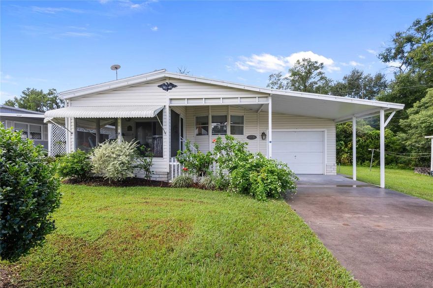 Welcome to Green Hill Estates, a desirable 55+ community in sunny Zephyrhills, Florida! This charming two-bedroom, two-bathroom 1992 Palm Harbor home is tucked away on a peaceful street at the edge of the community with no rear neighbors, offering privacy and tranquility. Here, you own the land and enjoy the benefits of affordable, well-maintained living. Inside, the open floor plan seamlessly connects the kitchen, dining, and living areas—perfect for entertaining family and friends. The spacious owner’s retreat at the back of the home includes a walk-in closet and an ensuite bath with a walk-in shower.  The guest bedroom also features a walk-in closet and is conveniently located across from the full guest bath which has a combination tub and shower. Updates to this home include vinyl plank flooring in the kitchen, guest bedroom, and both baths, the home has been freshly painted inside and the home has two sun tube skylights to bring in lots of bright natural light.  For added convenience this home has an inside laundry and is also being sold fully furnished. The oversized attached garage (30' x 11') offers plenty of space and includes an automatic door opener, with a workshop/storage area just beyond. At the front of the home, a screened room provides the ideal spot to relax and enjoy Florida breezes. On the outside, you’ll find low-maintenance vinyl siding, a lovely front garden, and a roof that was newly installed in 2025. Green Hill Estates also features an active clubhouse and shuffleboard courts for residents to enjoy, and the low annual fee of $432.00 which includes water. Conveniently located near shopping, dining, and excellent medical facilities, 6053 Ridgewood combines comfort, convenience, and value. Don’t miss your chance to make this lovely home yours—schedule your showing today!