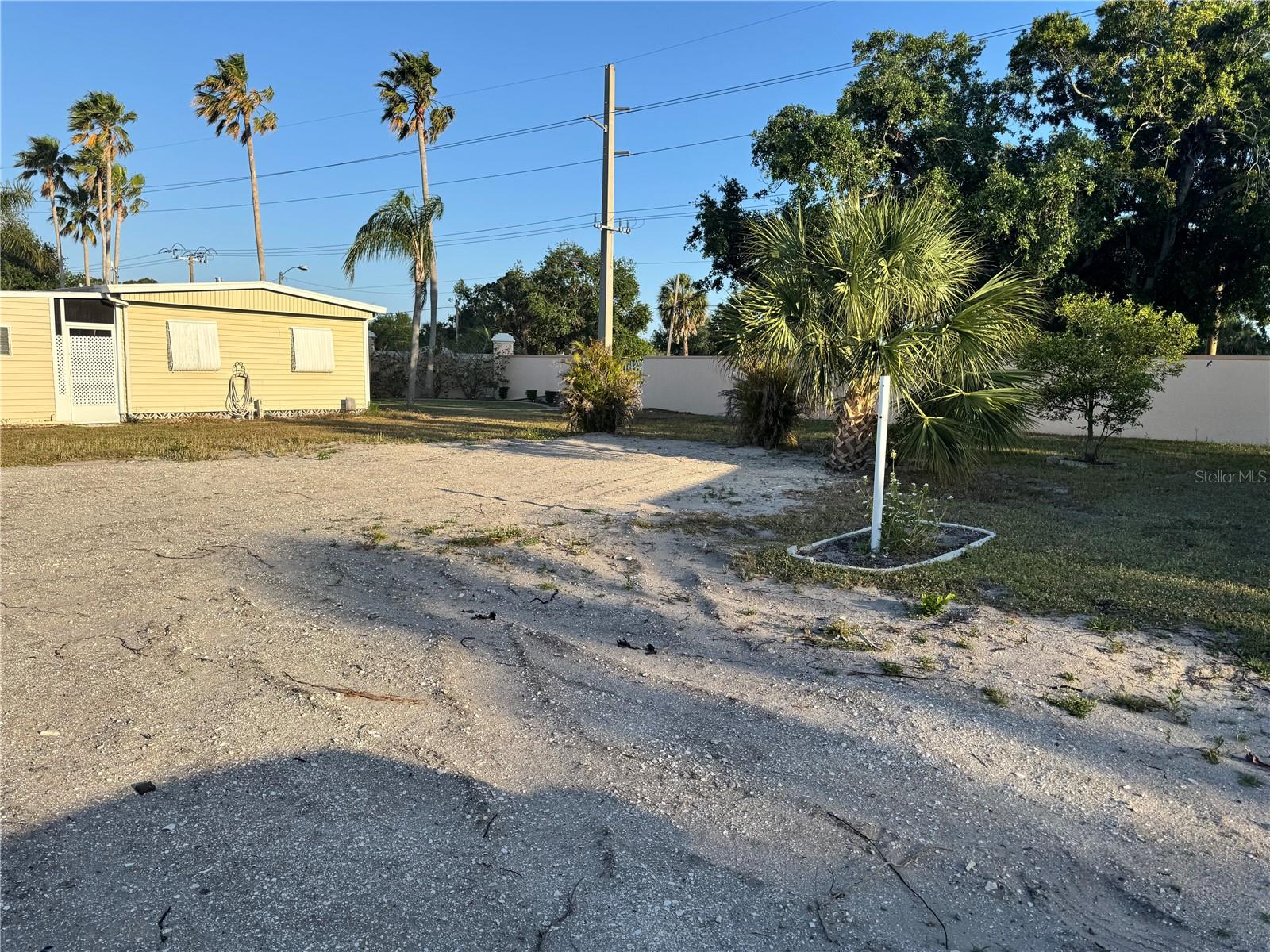 Build New in Golf Lakes – 55+ Pet-Free Community! This vacant 50’ x 80’ cul-de-sac lot is ready for your brand-new manufactured home (up to 30’ x 56’), with space to add a carport and shed—offering over 1,500 sq ft of potential living space. All hookups are already in place. Located in the highly desirable Golf Lakes community, residents enjoy ownership of the entire 121-acre park through a Co-Operative governed by an elected Board of Directors. The land beneath your home is yours via a renewable 99-year proprietary lease. Enjoy resort-style amenities including golf, a heated pool and spa, pickleball, basketball, and more. Maintenance fees include cable, internet, water, and sewer. Membership requires a background and credit check. Please note: Golf Lakes is a pet-free community. Don’t miss this rare opportunity to build new in one of Bradenton’s most active and beautifully maintained 55+ communities!