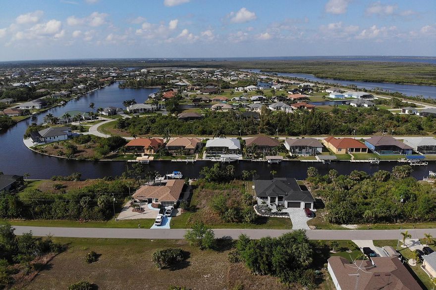 WATERFRONT PROPERTY! GULF ACCESS! PARADISE IS CALLING! Build your dream home in this waterfront Gulf Access community! Imagine stepping into your back yard and fishing from your property or jumping into your boat for a day of fishing or beach and island hopping! This fantastic lot gives you quick access to the Interceptor Lagoon near the northern portion of the community and the Charlotte Harbor with only one elevated bridge out. South Gulf Cove offers over fifty miles of navigable waterways and access to the Gulf of Mexico through the locks. This community has PUBLIC WATER and PUBLIC SEWER. The HOA in this deed restricted community is voluntary. You will enjoy the parks, community center, wide sidewalks and public boat ramp in this fantastic neighborhood. New construction is all around you in this popular growing area. Your new home is just 5 miles from Boca Grande with some of the most beautiful beaches you will find. If you choose to leave your new home you will be close to many other beaches, world class fishing, dozens of golf courses, restaurants, shopping, the new SunSeeker Resort, 2 Spring Sports stadiums and more! There are many miles of bike trails and thousands of acres of state parks within 10 miles of this location! Listing agent co-owns a construction company and will help with building plans and construction questions if needed. CALL TODAY