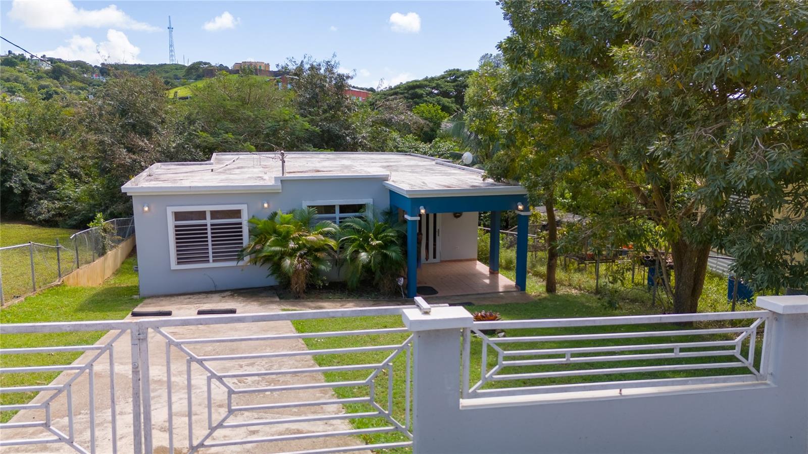 This 3-bedroom, 2-bathroom home is just an 8-minute walk from the ferry in Isabel Segunda, offering a central location near restaurants, shops and entertainment on the North shore of Vieques.
The house features tall ceilings, newer storm windows, tile throughout, and a functional layout over 1100 square feet. The very large primary bedroom includes a private balcony overlooking green space, a spacious walk-in closet, and an en suite bathroom with a jacuzzi tub and shower and additional storage.
A side stairway leads to the laundry area and a covered outdoor space, great for everyday use or casual gatherings. The backyard also includes an additional bathroom and an outdoor shower.
With solid concrete construction and a walkable location, this move in ready home is a straightforward choice in Vieques. A fully fenced yard in a manageable size of 1/5th of an acre (860 square meters) offers plenty of shade and comfort.