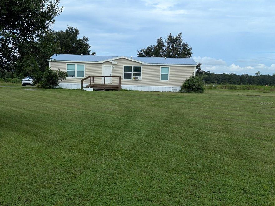 Looking for acreage for farming or pastures for horses or cattle, look no further. How about 20 acres, zoned agriculture (A-10).and located on a paved road just a bit out of town. Bonus for you, there is already a 3 bedroom 2 bath 2010 mobile home that has a metal roof and a brand new this week, central air and heat. This home is  spacious and offers split bedrooms. The kitchen has appliances and a breakfast bar big enough for 6 to 8 chairs.  There is also a nice size dining area for formal seating. The primary bedroom has a seating area and the large En Suite bathroom features a separate tub and also a walk in shower. Approximately 1200 sq ft of living area and a bit over 2000sq ft that includes a rear screened in porch and a front open deck . Formally a producing blueberry farm, this 20 acres offers several out buildings including a greenhouse area and a huge open pole barn open barn as well as smaller sheds.  There is a good sized pond on this property as well.  In other words, this place is ready for you to live and farm or raise your cattle or your horses, already equipped with shelter and a pond. This 20 acre property  offers a possibility of being able to build your custom home home, ( Buyer must confirm any building with DeSoto County Building and Zoning).  Make your appointment to visit this property.  Any furniture in home will be removed prior to closing.