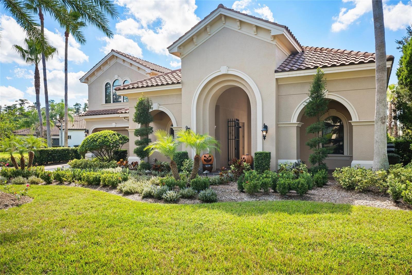 Welcome to Ladera Estates, one of Lutz’s premier gated communities, where privacy, elegance, and lakefront living converge. This executive estate spans 5,564 square feet of refined living space and offers an unmatched blend of craftsmanship, functionality, and modern upgrades, designed for those who appreciate luxury with purpose.
A stately tile roof and pavered drive framed by manicured landscaping lead to a charming front courtyard, setting the tone for the home’s timeless sophistication. Within the courtyard is a private in-law suite with a full bath and its own entrance, ideal for extended family or long-term guests. Enter the front door to soaring ceilings, architectural details, and walls of glass that create a bright, open flow perfect for entertaining or quiet retreat.
This five-bedroom, six-bathroom residence features a newly renovated chef’s kitchen that anchors the heart of the home, with professional-grade appliances, quartz surfaces, custom cabinetry, and an oversized island and bar top built for gatherings. Beyond, the expansive great room transitions seamlessly to the formal dining room, a sitting room with fireplace, and a dedicated theater room offering the perfect space for movie nights or entertaining guests.
Step outside to your own private resort and enjoy the sprawling pool, grilling pavilion, and outdoor kitchen overlooking the tranquil waters of Lake Merry Water. The expansive backyard provides room to relax or entertain while taking in peaceful lake views. Whether hosting a sunset dinner or enjoying a quiet morning coffee by the lake, this setting delivers the Florida lifestyle at its finest.
Practical features elevate everyday living, including a whole-house on-demand generator, newer mechanical systems, and a three-car garage with abundant storage. Located in a private, gated setting yet only a short drive to Tampa, this home offers the perfect balance of seclusion and convenience.
Every detail, from the stone finishes to the integrated sound system, reflects thoughtful design and enduring quality.