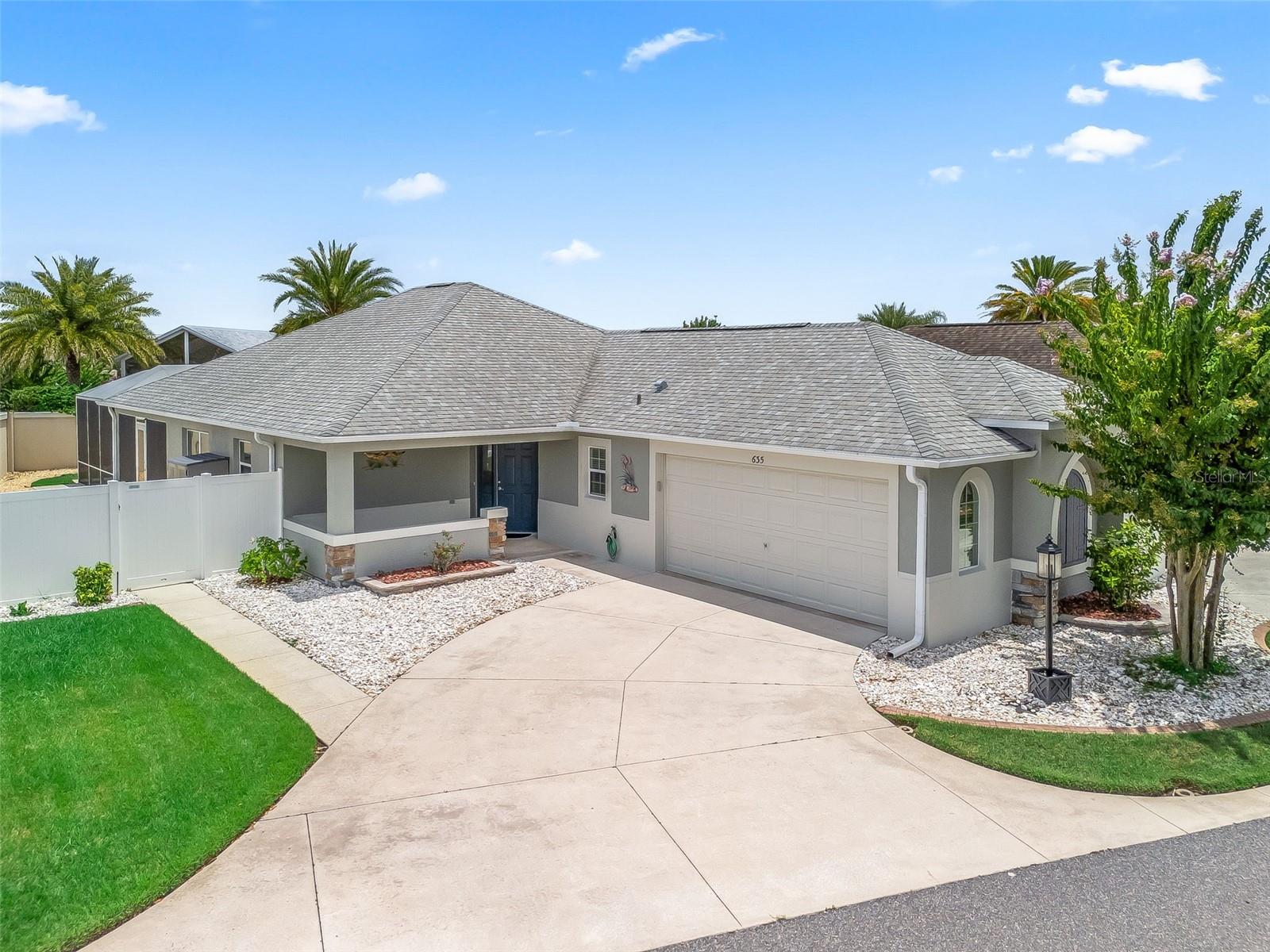 NO BOND! LOCATED NEAR LAKE SUMTER LANDING! 2 CAR GARAGE! 3 Bed/ 2 Bath AVONDALE Courtyard Villa located on a Large Corner Lot with a Private Fenced Yard in HACIENDAS of MISSION HILLS, just minutes from Lake Sumter Landing and Spanish Springs! This home offers 1,788 SQ. FT. Climate Controlled Living featuring an Open Floor Plan with High Ceilings and TILE flooring throughout. A Covered Front Porch welcomes you, leading into a Tiled Foyer. Once inside the Vaulted ceilings create a light, open, and spacious feel. Two sets of sliding glass doors connect the indoor and outdoor spaces, one set from the living room and the other from the kitchen both providing access to the Lanai and then to the Large Screened Birdcage boasting a BULLFROG SPA. The spacious and open Kitchen is beautifully appointed with Recessed Lighting, Solid Wood Cabinetry, Pull-Out Drawers, Pantry, Stainless Steel Appliances, Tile Flooring, and a Center Island. The owner’s suite has a Tray Ceiling, Walk-In Closet, and a luxurious En-Suite Bath with Dual-Sink Vanity, Tile Flooring, Water Closet, a Tiled Step-In Shower and Solar Tube. Bedroom 2 offers a Closet, Ceiling Fan and is ideal for guests, a home office, or hobbies. Bedroom 3 includes a Vaulted Ceiling, Ceiling Fan and a Closet. The Guest Bathroom includes a Tiled Tub/Shower Combo, Vanity, Tile Flooring and nearby Linen Closet. The Garage has an Epoxy Floor, Utility Sink, Pull-Down Attic Stairs for extra storage and Insulated Doors. There is also a Fenced-In Grass Yard which is convenient for pet owners. This villa is just down the street from the Mission Hills pool and nestled in a quiet neighborhood. Located close to Lake Sumter Landing and Spanish Springs where you can enjoy Shopping, Dining and Live Entertainment / Dancing nightly! With its two-car garage and central location, this home won’t last long! Call today for your private showing!