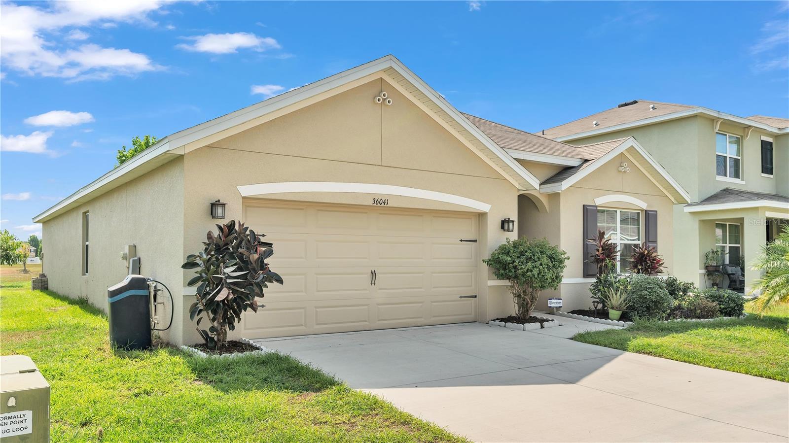 MUST SEE!! This beautiful 4 bedroom, 2 bathroom home, built in 2019, is like new! The kitchen offers an abundance of cabinet space, brand new stainless-steel appliances, a water filtration system, and a large island with a breakfast bar, offering ample space for meal preparation and casual dining. The dining area, adjacent to the kitchen, features glass sliding doors that fill the space with natural light and direct access to the covered lanai. The living room leads directly to the main bedroom featuring an ensuite bathroom equipped with a double sink vanity, a contemporary stand-up shower, and a spacious walk-in closet providing ample storage space. The home's split bedroom floor plan places the remaining three bedrooms on the opposite side, ensuring privacy for all occupants. Each bedroom has built-in closets and shares access to the second bathroom, including a convenient shower-tub combo. The laundry room is across the hallway from these bedrooms, a practical addition that enhances the home's functionality. This laundry room also provides direct access to the two-car garage, offering convenience and additional storage options. Residents of this community enjoy access to amenities, including a clubhouse with a swimming pool and a covered playground, making it an ideal home for families seeking a blend of comfort, style, and community living.