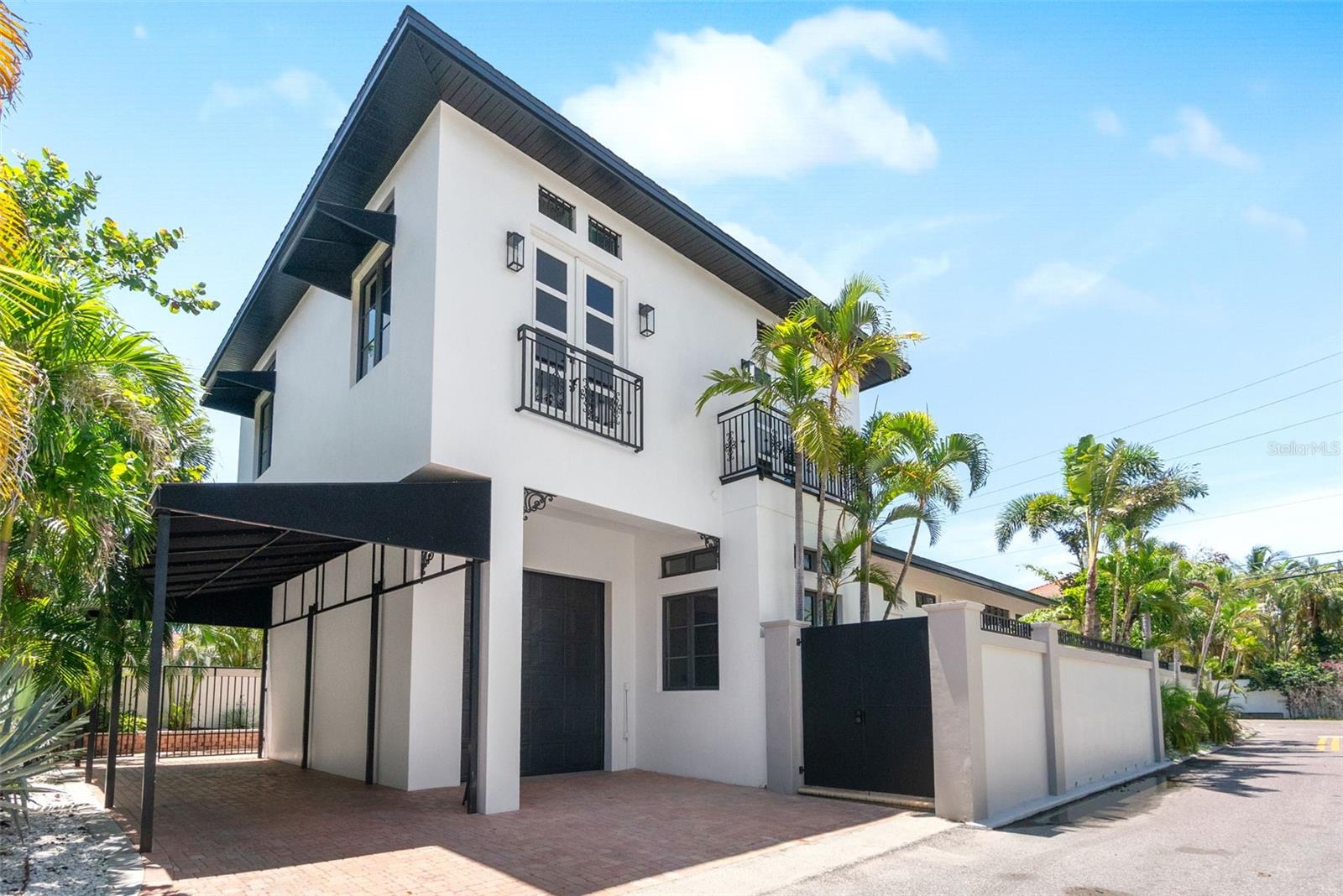 One or more photo(s) has been virtually staged. Whether you're seeking a sophisticated primary residence or a high-performing Airbnb investment, this fully renovated 5-bedroom, 4-bathroom coastal contemporary pool home offers the best of both worlds! Ideally situated on an oversized corner lot on Siesta Key and located within city limits, this MOVE-IN READY gem qualifies for 7-day minimum rentals, making it a prime opportunity for full-time living, or a lucrative short-term vacation rental. Nestled behind a grand privacy wall, this unique masterpiece provides a true tropical retreat for you and your guests. From the moment you step inside, you'll be captivated by the soaring 12-foot ceilings on both levels, the open concept floor plan, and elegant travertine marble flooring throughout. The primary suite is conveniently located on the first floor, offering both comfort and privacy with French doors that lead to your outdoor private patio. Custom hurricane-impact French doors wrap the entire main living area, seamlessly blending indoor and outdoor spaces, creating a dramatic view of your tropical oasis. Enjoy peace of mind with HURRICANE-IMPACT WINDOWS and DOORS installed throughout the home. Ample on-site parking for up to 5 vehicles adds exceptional convenience for both owners and guests. The chef’s kitchen is fully equipped with high-end finishes, including a gourmet gas range and hood, custom wood cabinetry, quartz countertops, an oversized BLANCO sink, and wine cooler, perfect for hosting and entertaining. Some of the recent upgrades include two brand-new HVAC systems (one for each level), new hot water heater, all new appliances, fresh interior and exterior paint, new landscaping and irrigation, and new electrical wiring and plumbing complete with a convenient manifold in the garage for your shut off valves. The newly resurfaced pool, paired with new pool equipment, invites you to relax in total serenity. Surrounded by lush, tropical landscaping, the spacious outdoor area offers plenty of room to entertain, host family gatherings, or simply soak in the Florida sunshine in total privacy. This unique masterpiece is located just four blocks from the nearest beach access at N. Shell Rd, and near the North bridge for convenient access on and off the Key. Take a short ride to the world-famous Siesta Key Beach and Village, where you'll enjoy fine dining, boutique shopping, and vibrant island living. Known for its powder-soft quartz sand, Siesta Key consistently ranks among the top beaches in the United States, making this a premier location for homeowners and investors alike. Don’t miss your chance to own a slice of paradise in one of Florida’s most desirable coastal communities. Call today to schedule your private showing!