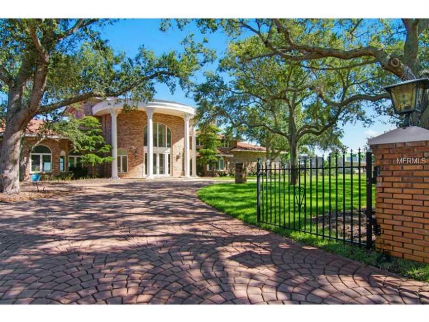 This grand estate with expansive views of the Manatee River is a blank canvas ready to be made into a masterpiece! This home boasts over 11,000 sq ft of living space and over 14,000 sq ft under roof.  The home was originally built in 1973, extensively remodeled in the 80's and 2009 with updated electrical, plumbing, multi-zoned air conditioning system, beautiful warm wood flooring, new windows and doors. This is the perfect home for entertaining from the 1,900 sq ft great room with wet bar to the spacious kitchen (ready for appliances) as well as the butler's kitchen in the oversized laundry room and the grand entrance foyer with curved staircase. This 3-story home features 3 large bedrooms, all with en suite baths plus den/office. Seller will give credit at closing to add 2 bedrooms per builder plans. Additional rooms include a second story loft, third floor bonus room off of the bedroom and 2 half baths. All bedrooms have large walk in closets. The ground floor master suite boasts a wood burning fireplace, two walk in closets, washer/dryer hook-up and almost 1,000 sq ft of space! The master bath has a large tub with separate shower and panoramic views of the river. In addition to the fireplace in the master suite, the home has 3 additional fireplaces -- in the kitchen area, second story bedroom and third story den. This one owner home is ready for a new owner to make it their masterpiece!