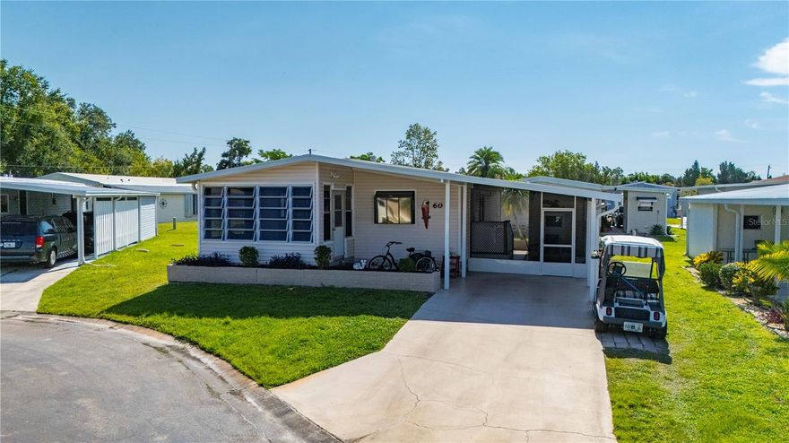 Welcome to this absolutely charming 2-bedroom, 2-bath manufactured home located in a highly desirable 55+ co-op community. From the moment you arrive, you’ll notice how well cared-for and thoughtfully updated this home is. The spacious screened-in lanai, newly replaced in 2023, offers the perfect space for outdoor relaxation or entertaining. Just off the lanai is a large storage shed complete with a washer, dryer, and a small workshop area—ideal for hobbies or extra storage. Inside, this home is full of character and personal touches. The kitchen features a beautiful plant bay window, ample counter space, and plenty of cabinetry for all your needs. The open living and dining areas are bright and spacious, with newer luxury vinyl flooring running throughout the entire home. The bathrooms are well-appointed, with the primary bath offering a relaxing Jacuzzi tub. Both bedrooms include generous closet space, and the enclosed Florida room at the front of the home provides a sunny, comfortable space to enjoy your morning coffee or watch the neighborhood activity. Major updates include a brand-new HVAC system installed in 2024, a new vapor barrier added in 2023, and a durable membrane roof for long-term peace of mind. Furniture and the golf cart are negotiable, making it easy to move right in and start enjoying the Florida lifestyle. This welcoming community is ideally situated close to shopping, top-rated golf courses, restaurants, entertainment, excellent fishing, and the gorgeous blue waters of Florida’s Gulf Coast beaches.