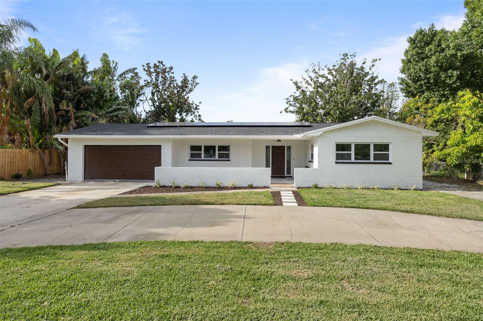 Completely Renovated & Move-In Ready! This solid block 3-bedroom, 2-bathroom home has been updated from top to bottom with quality finishes and energy-efficient upgrades. Featuring a brand-new roof and paid-off solar panels, you’ll enjoy long-term savings and peace of mind. Inside, you’ll find engineered hardwood floors throughout, fresh interior paint and trim, and new hurricane impact windows that fill the space with natural light while providing added safety and insulation. The kitchen has been completely remodeled and features a beautiful island with extra cabinets on the backside that also is an eat-in space as well. The quartz countertops, farmhouse sink, and new appliances make this space a chef's dream. The bathrooms have been beautifully updated. The primary bathroom contains marble floors and beautiful finishes. The primary bedroom has his and her closets and is separate from the other two bedrooms. The exterior boasts fresh paint for modern curb appeal and new sod for the front yard. Updates include new roof (2025), new hot water heater (2025), new plumbing from the slab up (2025), new impact windows (2025), solar is paid off, new irrigation, new tile on front porch, interior and exterior paint, and new planters. Centrally located close to shopping, dining, and beaches, this home blends style, comfort, and efficiency—ready for you to move in and enjoy! House is NOT in a flood zone and did NOT flood.