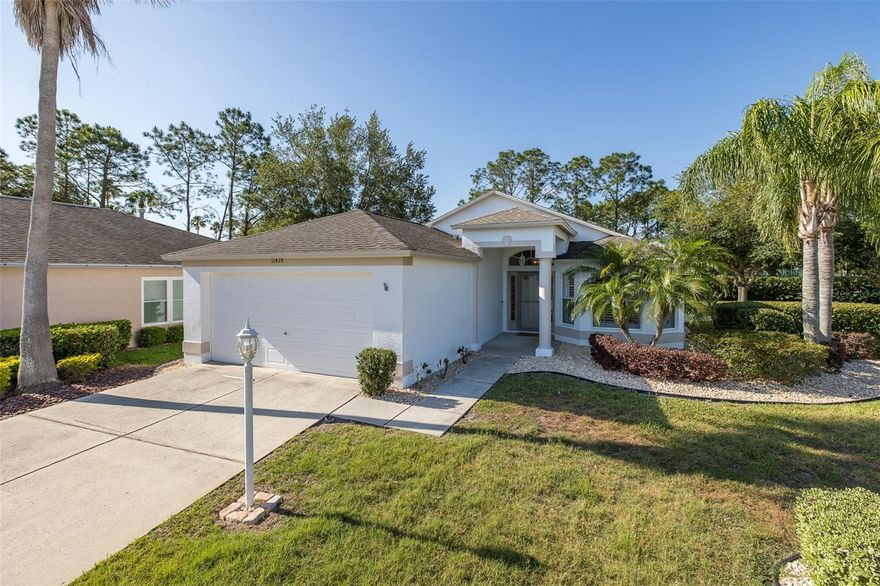 ** NEW PRICE ** HERITAGE SPRINGS | 55+ Living at Its Best! Exceptional Value in One of Trinity’s Most Coveted Communities! Welcome to Heritage Springs, where resort-style living meets everyday comfort. Nestled on one of the most desirable lots in the community, this impeccably updated 3-bedroom, 2-bathroom home (former model) is the one you’ve been waiting for! From the moment you arrive, the expansive driveway — one of the largest in the entire community — sets this home apart. Step inside and you’ll immediately notice the thoughtful updates and designer finishes that make this residence truly move-in ready. Rich wood flooring flows throughout the open floor plan, complemented by designer tile, soaring ceilings, and an abundance of natural light that makes every room feel bright and airy. The heart of the home is a stunning kitchen featuring crisp white cabinetry, gleaming granite countertops, and newer stainless steel appliances including a brand new stove (2024)— perfect for everything from morning coffee to entertaining guests. The adjacent dining room opens through sliding glass doors to the sprawling enclosed lanai, where complete privacy and lush, park-like views create your own personal oasis. The generous living room offers the ideal setting for gatherings with family and friends. Retreat to the spacious primary suite, where serene views of the park-like surroundings greet you each morning. Two large walk-in closets provide abundant storage, while the luxurious en suite bath impresses with his-and-her vanities and a large walk-in shower. Two additional well-sized guest bedrooms each offer ample closet space and share a tastefully appointed guest bath with a neutral vanity and tub/shower combo. A convenient inside laundry room rounds out this perfectly appointed floor plan. Peace of mind comes standard with this home, thanks to a long list of major updates already taken care of for you. The roof was replaced in 2020, the A/C system replaced in 2020, and the water heater replaced in 2022 — giving you confidence in the home’s most critical systems for years to come. Additional updates include a new garbage disposal (2020), new wood flooring in bedrooms (2025) (zero carpet) new garage door opener (2022), and a new sprinkler control box (2024), new faucets (2025) ensuring this home is as functional as it is beautiful. Additional highlights include custom plantation shutters throughout, a freshly painted neutral interior and exterior (2025), and an oversized garage that provides exceptional storage and functionality. Step outside your door and you’re just steps from the newly remodeled clubhouse, featuring a gorgeous resort-style swimming pool, many planned activities with lifestyle director and a full-service restaurant — because at Heritage Springs, every day feels like a vacation. Golf anyone? Enjoy the newly improved 18 hole golf course! Security - 24 hour manned Guard Gate! Ideally situated close to everything Trinity has to offer, including premier shopping, dining, medical facilities, and easy access to the area’s finest amenities. Short drive to Tampa International Airport, Clearwater/St. Pete Airport & beautiful local beaches! This is Florida living at its absolute finest. Don’t let this gem slip away — start living the dream today. Move-in Ready!