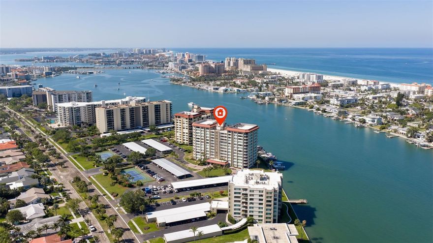 Live the ultimate beach lifestyle in this waterfront condo in Island Estates, Clearwater, just minutes from world-famous Clearwater Beach. Located on the 5th floor, this spacious 2-bedroom, 2-bath residence offers nearly 2,000 square feet and showcases sweeping water views of the Mandalay Channel, Clearwater Beach, and the Gulf, creating a daily backdrop of unforgettable sunsets and water views. Enter into a bright, open-concept layout filled with natural light and framed by stunning western-facing views from nearly every room. The expansive living and dining areas flow seamlessly to a private balcony, where you can unwind each evening as the sun sets over the Gulf. The updated kitchen features stainless steel appliances, granite countertops, and generous prep and storage space, making it both functional and inviting for everyday living or entertaining. Both bedrooms enjoy water views, with the primary suite offering direct access to its own private balcony, the perfect place to start and end your day. The primary suite includes a large walk-in closet, dual vanities, and is incredibly spacious. Even more convenient, there is a full interior laundry room with a laundry sink. A covered parking space is also included with this condo. Located in the highly sought-after Island Estates community, this condo places you in the heart of Clearwater’s coastal lifestyle, close to beaches, dining, shopping, and everything that makes this area so desirable. Whether you're looking for a full-time residence or a beach retreat, this property offers the perfect opportunity bring your vision and make it your own!