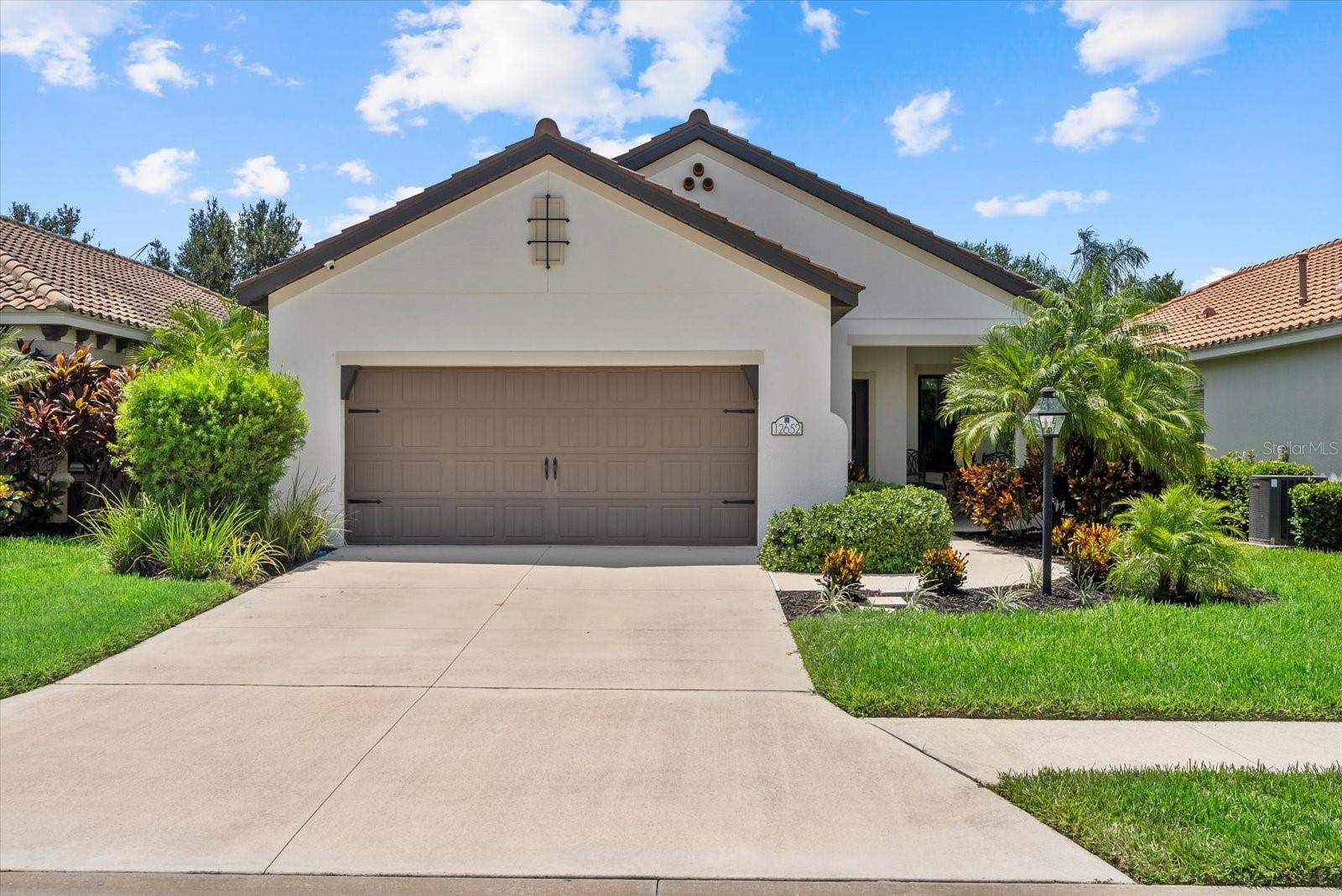 Welcome to Your Dream Home in Indigo at Lakewood Ranch.
Discover this beautifully designed, custom-built 3-bedroom, 2-bathroom home with a versatile flex room/office, located in one of Lakewood Ranch’s premier gated communities. The thoughtfully planned split floor plan offers maximum privacy, with the office conveniently placed at the front of the home for quiet productivity.
At the heart of the home, the spacious great room brings together the kitchen, dining, and living areas in an open-concept layout perfect for entertaining. The chef-inspired kitchen features white shaker cabinets, stone countertops, a stylish tile backsplash, stainless steel appliances, and an inviting island for casual gatherings.
The large primary suite is tucked away at the rear, complete with a walk-in closet and a spa-like en suite bathroom. Step outside to the extended private lanai to savor breathtaking Florida sunsets, or start your mornings with serene sunrises from the covered front porch.
Residents of Indigo enjoy low HOA fees that include lawn care, trimming, irrigation, mulching, and edging—plus access to the vibrant amenities center with a kitchen, state-of-the-art fitness facility, resort-style pool, pickle-ball and bocce courts, a playground, and a full-time lifestyle director who keeps the community calendar buzzing.
Ideally located near restaurants, shopping, grocery stores, and major highways, you’ll have quick access to Sarasota, Tampa, St. Pete, Orlando, top-rated schools, community parks, and the world-famous Gulf Coast beaches.
This home is move-in ready—just bring your suitcase and start living the Florida lifestyle!
