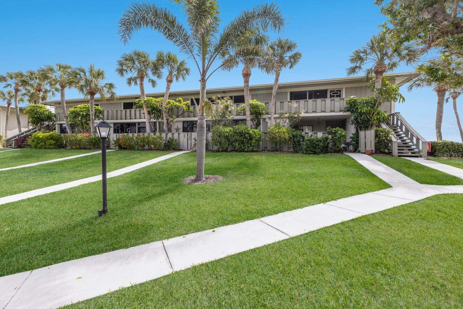 Tucked away in the serene and impeccably maintained West Bay Point & Moorings community, this second floor, end unit condo offers the ideal blend of comfort, privacy, and stunning water views. Thoughtfully designed with two spacious bedrooms, each featuring its own ensuite bath, this condo ensures both convenience and personal retreat. With both a screened front porch and a larger screened back porch, outdoor living is effortless, especially when the backdrop is the sparkling Intracoastal Waterway where sunrises, sailboats, and seabirds become part of your daily routine. Whether you're sipping morning coffee or unwinding after a long day, the views are simply unforgettable. In addition to its tranquil setting and beautifully maintained grounds, this condo offers excellent investment potential, with the association permitting monthly rentals, making it just as appealing for seasonal stays as it is for year round living. Additional features include turnkey furnishings, electric hurricane shutters, new roof being installed, storage and more. Community amenities include a heated pool, tennis courts and boat dockage, adding even more to the relaxed, coastal lifestyle this condo provides. Don't let this perfect little slice of island life get away and make it your waterfront retreat today!