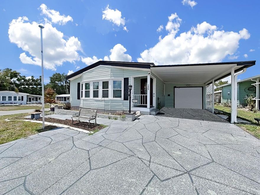 WONDERFUL 2 Bedroom, 2 Bathroom home in the 55+ community of Foxwood Lake Estates where you OWN THE LAND!!  Lots of unique features in this home that make it stand out from the rest.  You get a coastal feel with the shiplap walls, a spacious separate living room and a den off of the kitchen, both shower stalls are updated with tiles, 2 skylights allow even more natural light in the home, tons of storage and all of it on a corner lot!  The Florida room is located off of the den and a built in area with a desk makes any paperwork/bills convenient.  There is a metal roof, the A/C was replaced in 2019, replacement windows, a generator hook up, a golf cart plug in the garage and a workshop connected to the garage!!  The furniture in the photos will remain so no need to furnish a whole home after your purchase!  This well-maintained home is available now, come and take a look!  Sunshine awaits you in this active community!!  Foxwood Lake Estates is located within 5 miles of I-4, restaurants, shopping, hospital, movie theatre and more! Situated between Tampa and Orlando, there is so much to do and see! This active community features a large clubhouse, game room, billiards room, sauna, fitness center, library, large heated pool, hot tub, pickle ball courts, shuffle board courts, bocce ball courts, basketball hoop, paved walking path around the lake and so much more!! Lots of events happening here like pot-luck dinners, entertainment series, dances, Wednesday morning coffee, raffles, bingo, zumba, pilates, line dancing lessons, pool aerobics, golf cart parades and many holiday celebrations! Schedule your showing today!
