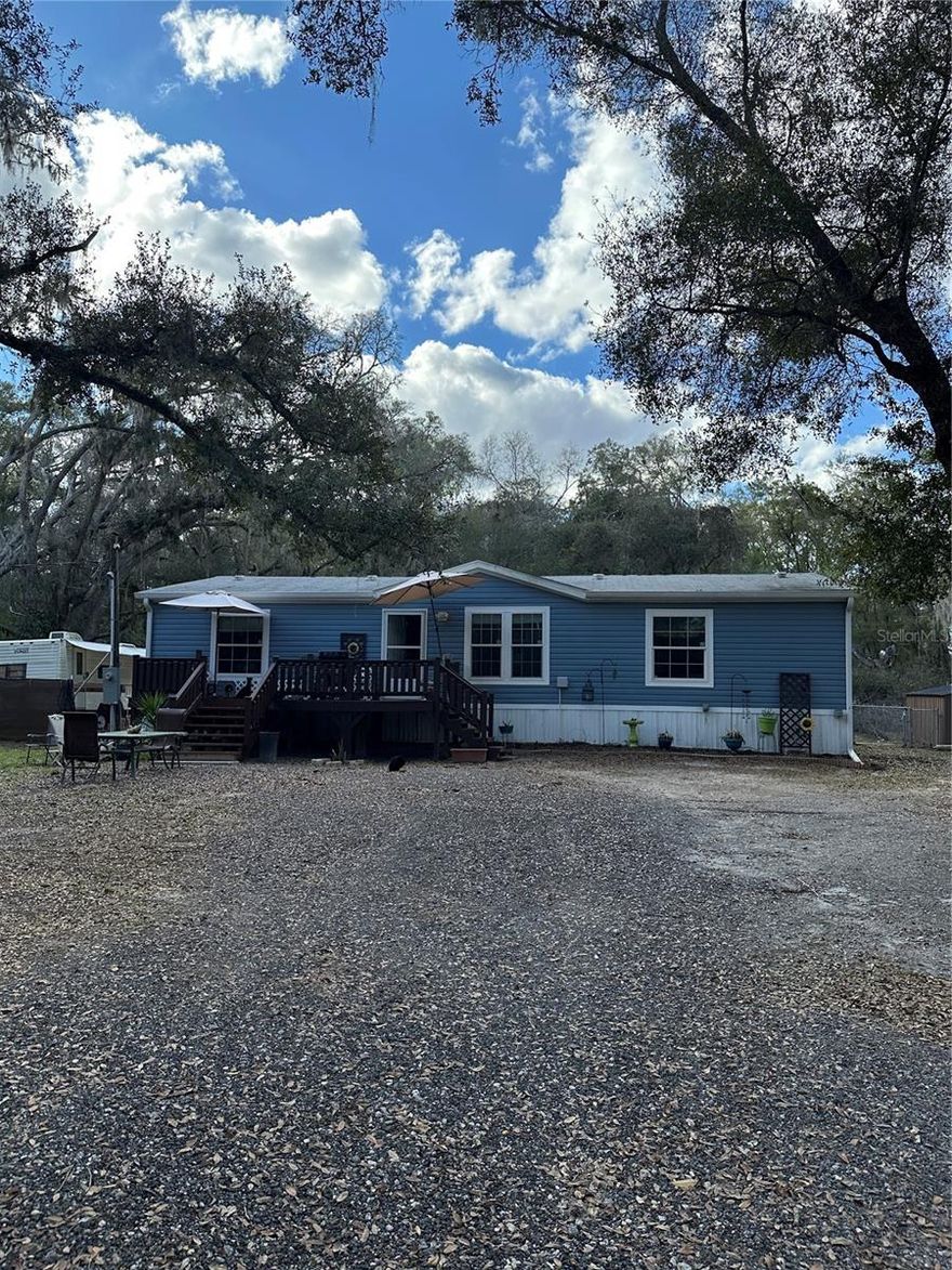 Seller Motivated. Bring your best offer for this 5 year old 3 bed / 2 bath Manufactured home with .88 acres consisting of 4 lots.This home has a nice sized Front deck with two sets of stairs leading to the front door. Step inside to the living area that is open to the kitchen and dining room. The kitchen Island with a sink, doubles as a breakfast bar. The  recessed lighting gives a modern feel to the home. Appliances are all in good condition at 5 years of age. The Master bedroom has a walk-in closet, ceiling fan, and an en suite bath with walk in shower and garden tub. Bedrooms 2 & 3 are on the other side of the home, both with walk-in closets and cieling fans. The main bath is located next to the secondary bedrooms and convenient to the main are of the house. The Laundry/utility room is off the kithcen. I has a linen clost and a walk-in pantry, room for a small chest freezer or a coat rack/bench.  The rear yard is partially fenced. In the side yard are 2 Storage Sheds . On the South side of the home is the Aerobic Septic System (5 years old), saving you the cost to convert by 2030. HVAC is 5 years old. Main Well is located behind the house and a second well (decommisioned) on the North side of the home should you choose to make it operational again for a irrigation sytem or other use. This home has been lived in so we expect you will want to paint, the 2nd bedroom door is a little damaged an may need replacing, and the 3rd bedroom has a spot in the laminate that is peeled up and you might want to replace it too.  This home is 10 minutes from Crystal River, FL, 24 minutes to Ft Island Gulf Beach, 20 minutes to Homosassa Springs Wildlife Park, 20 minutes to Rainbow Springs State Park in Dunnellon, and 30 minutes to Inverness, FL. It's just minutes away from some of the best of Florida and only 1 1/2 hours to Tampa International Airport and 1 3/4 hours to Orlando International Airport. Let's not forget Disney World, just under 2 hours away! Schedule your showing today!!! Pets on Premises (dogs and cats). Dogs are crated for showings. Do not touch pets.