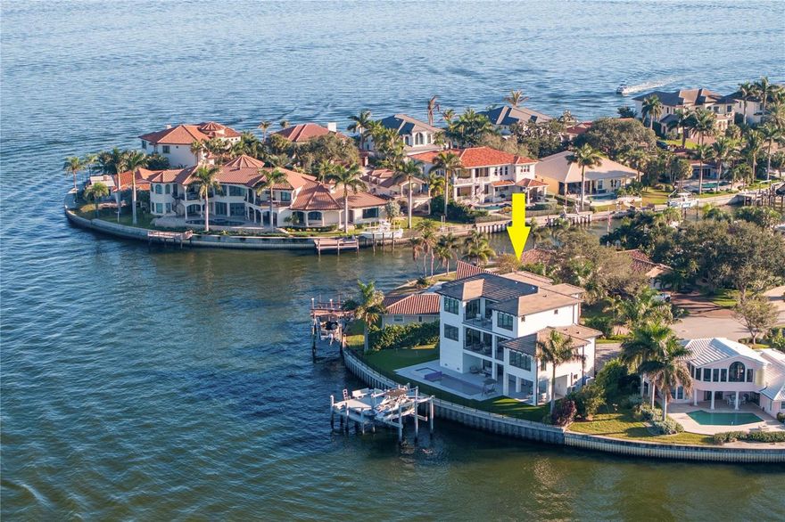 Magnificent Contemporary estate in the premier waterfront community of Venetian Isles with endless views of Tampa Bay. The perfect boater’s paradise is found in this outstanding waterfront location offering a rare 135 feet of water frontage on a quiet cul-de-sac. Recently completed in 2021 featuring the latest building codes, this elevated design features block construction and impact windows/doors, delivering refined living spaces and state-of-the-art appointments throughout. A dramatic modern double door entry welcomes you to the most spectacular water and city of Tampa skyline views from almost every room. Designed for brilliant entertaining, open and light-filled living spaces provide a gracious grand room with fireplace and sliding doors to the covered terrace and dining area. A designer chef’s kitchen features top-of-the-line appliances (Wolf/Sub-Zero), Wolf 6-burner gas range, center island with waterfall countertops, butler’s pantry and wine storage. This main level features 2 ensuite guest bedrooms, powder bath and large bonus room. The third level features a private primary retreat boasting a generous sitting room and terrace access, panoramic views, large closet, luxurious bath with soaking tub and generous glass-enclosed shower. The 4th ensuite bedroom, laundry room and den/office complete the third level, with a large waterfront terrace. On the pool level enjoy a covered lanai with full outdoor kitchen (grill/hood/sink/refrigerator) heated saltwater pool/spa, and custom putting green. Savor breathtaking sunrises and endless days on the water with a new elevated concrete seawall, expansive entertaining dock and 25,000 lb boat lift, with easy access to the Gulf and beaches and the best fishing on the bay. Additional features include a 3-level elevator, Control 4 / Surround Sound, power shades, designer lighting, full home generator and 4+ car garage. Offering easy access to St. Pete’s vibrant culture and nightlife, beaches, shopping, dining and entertainment, embrace the coveted Florida waterfront lifestyle. Available fully furnished at additional cost. Seller's Flood Insurance of $382/year can be assumed by a buyer.
