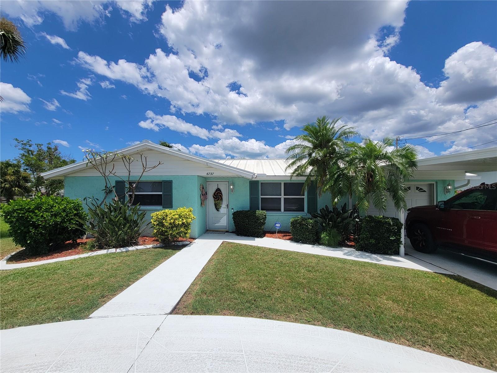 Live where others vacation! This beautifully remodeled waterfront pool home has it all- with a private dock, boat lift, and luxury upgrades throughout! Just a short boat ride to the Gulf!
This 3-bed, 2-bath home is Florida living at its finest – thoughtfully redesigned in 2024 to make you feel the coastal living inside and outside of the home!
This 3 bedroom / 2 bath has ceramic flooring (installed in 2023) throughout the entire home (resealed and cleaned 2024). Exterior paint was done in 2020 and interior was done in 2024. This stunning kitchen features custom navy Fabuwood soft-close cabinets, gorgeous Cambria quartz countertops, decorative herringbone blue backsplash and a large custom island. The kitchen has a pass through to the combo living and dining area that overlooks the pool and canal. The main bathroom matches the kitchen’s upscale finishes and includes a walk-in shower with bench seating and designer double vanity. The laundry room is heated/cooled and offers washer/dryer, an extra fridge, storage and access to the 2nd full bath. An exercise mat will be laid in the 1/2 garage. Carport - for shaded parking.
Step outside to your private oasis: Large covered patio with ceramic tile off of the home before you head onto the screened in pool enclosure. The concrete pool has solar heating. The large deck offers a floating dock for those quick on the go boating weekends. Stop paying marina fees with this 10k lb boat lift- with 2 new davit motors. You also have a shed for extra storage. Both the decks have new composite material, which offers durability and low maintenance. Tiki hut on the deck is perfect for entertaining or watching the sunset. Sea wall was done in 2011.
Just a few of the homes amazing features: a metal roof, brand new A/C unit with raised condenser (2024), new hot water plumbing, Electrical panel (200 amp) was installed in 2002, irrigation system, hurricane-rated windows, new doors and slider 2024.
This home is handicap accessible.
**Hot tub is excluded**
Located just minutes from the Gulf, enjoy fishing, boating, and sunset cruises from your own backyard!