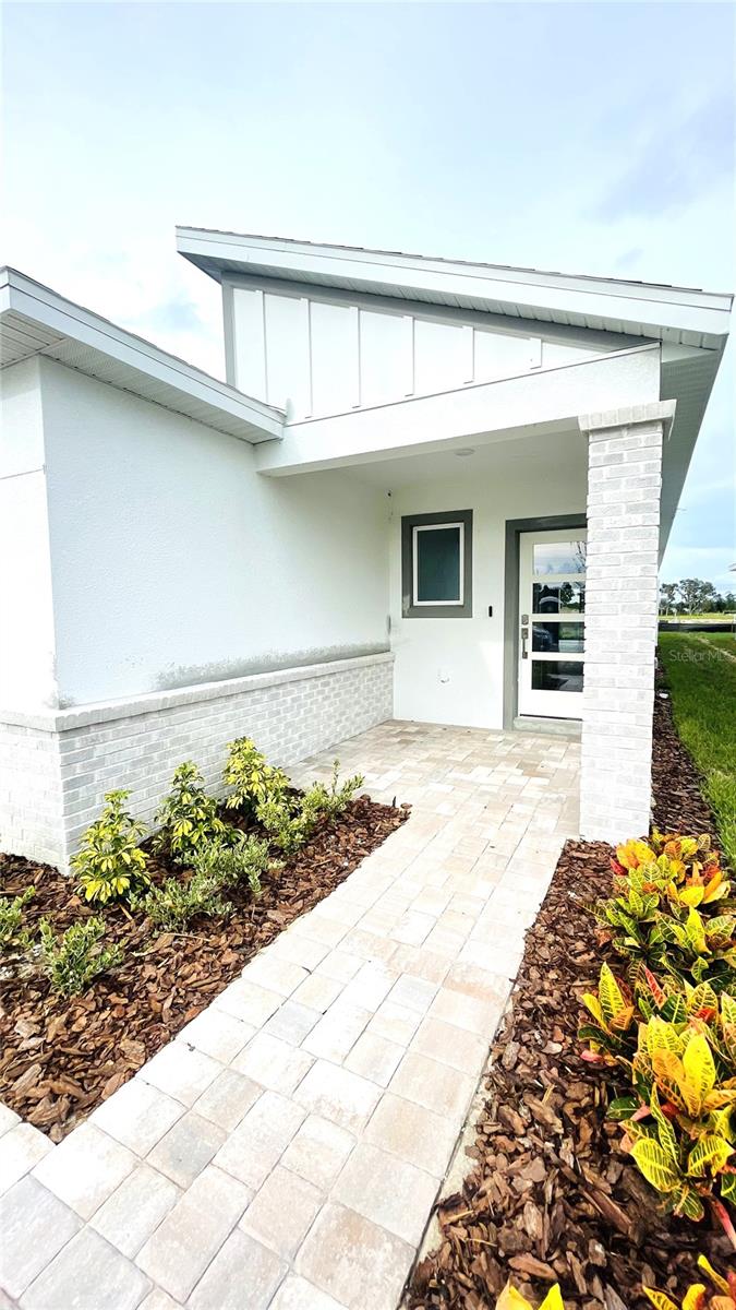 Welcome to the Atlantic floor plan at Willowbrook North, a beautifully crafted new construction home in Winter Haven. This 3-bedroom, 2-bathroom home combines modern design with functional living in a bright, open-concept layout. At the heart of the home, the kitchen features a massive granite island and elegant cabinets, perfectly centered between the dining and living areas to create the ideal space for gatherings and entertaining. The split-bedroom design provides privacy, with two spacious bedrooms and a full bath at the front of the home, while the primary suite is tucked in the back and showcases double vanities with granite countertops, a fully tiled walk-in shower, and a large walk-in closet. Thoughtful details include granite surfaces throughout, a paver driveway, a covered lanai with pavers, and a spacious backyard perfect for outdoor living. Set in the peaceful Willowbrook North community, just 8 minutes from Downtown Winter Haven and 4 minutes from US-27, this home offers the perfect balance of comfort, style, and convenience close to shopping, dining, and entertainment.