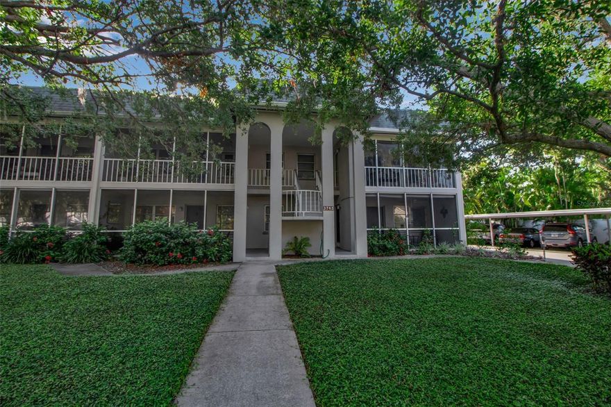 One or more photo(s) has been virtually staged. Welcome to your peaceful retreat in the heart of Sarasota! This beautifully maintained 2-bedroom, 2-bath condo is perfectly situated on the second floor, offering enhanced privacy, with serene views and filtered natural light throughout this West-facing unit. Enter through a spacious, oversized screened front porch—ideal for enjoying your morning coffee or relaxing with a glass of wine as the sun sets. Inside, you'll find a bright and airy split-bedroom floor plan featuring new luxury vinyl flooring, fresh paint, and updated stainless steel appliances in a move-in ready space just waiting for your personal touch. The large open concept living and dining area provides a comfortable layout for entertaining, while the inside utility closet adds everyday convenience. Surrounded by mature oak trees and nestled on a tree-lined residential street, this condo offers a peaceful, park-like setting in a highly desirable neighborhood. Located just minutes from the world-famous Siesta Key beaches, Southside Village, shopping, dining, and vibrant downtown Sarasota, you’ll love the blend of quiet comfort and close-to-everything convenience.  Don’t miss this opportunity to own your slice of Sarasota paradise in this prime Sarasota location—schedule your showing today!
