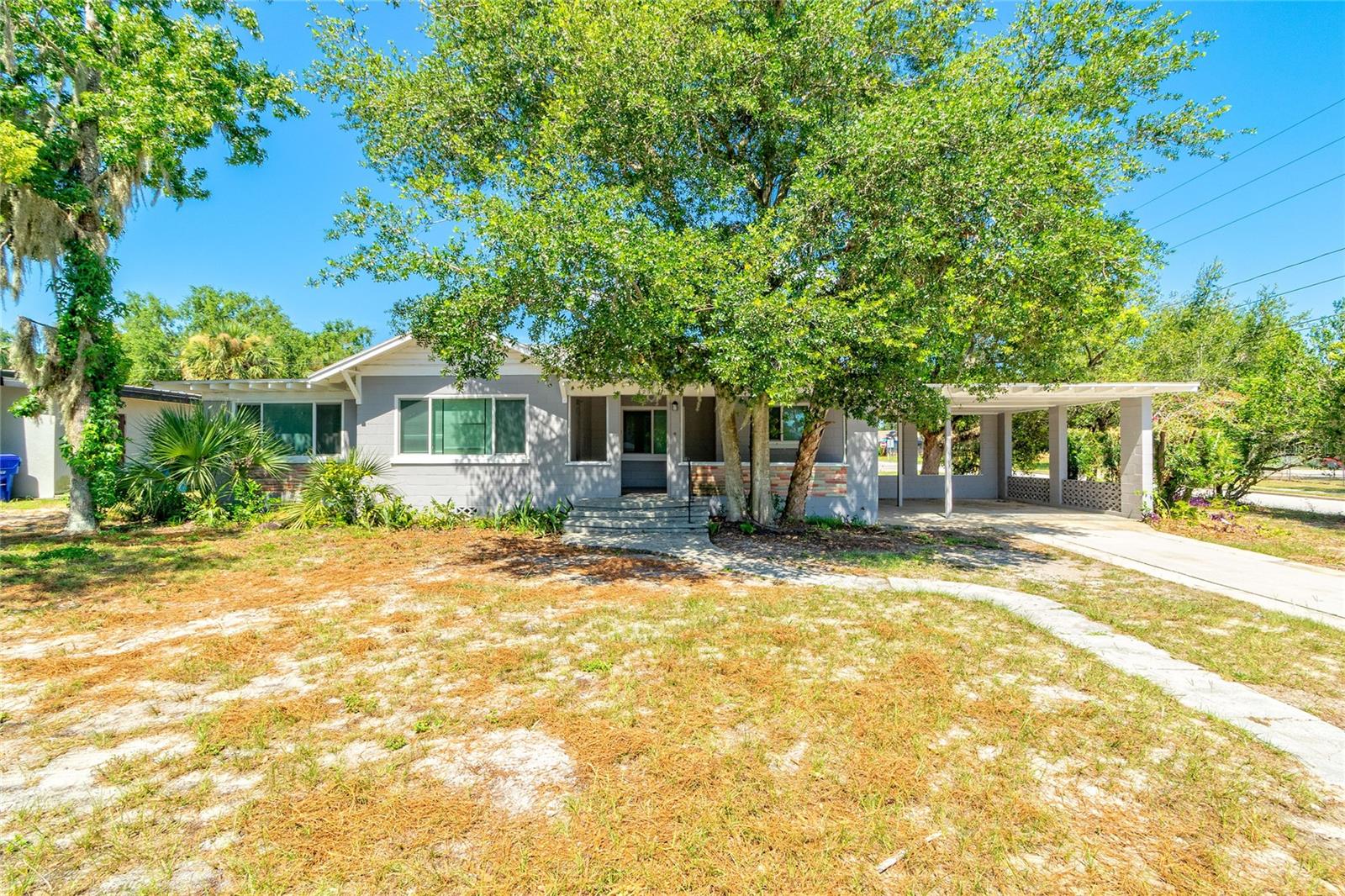 Directly Across the Street from Tavares High School! 2025 Renovation Complete. This 4 bedroom & 2 full bathroom Single Family Home with Carport features Kitchen Cabinets with Granite Counters, New Bathrooms, Luxury Vinyl Plank Flooring, Ceiling Fans in Bedrooms & Living Room.