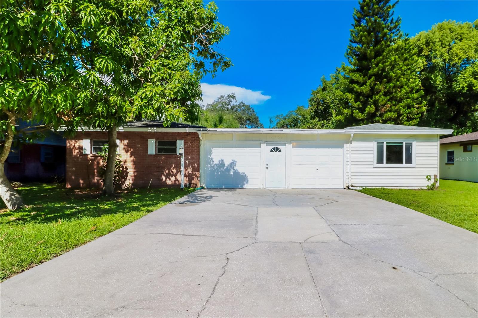 Come check out this unique and rare 3 bedroom, 2 bathroom, 2 car garage home in Floral Gardens/Lake Magdalene! Be enchanted by the craftmanship of its time with gorgeous built-ins in multiple rooms and plenty of character while also enjoying updates such as new LVP flooring, custom lighting throughout, new kitchen with granite countertops, updated bathroom vanities, and more!!! Enjoy ultimate privacy and peace of mind with front door access located inside of your garage. The garage also includes access doors to a fully functional workshop/storage room perfect for a hobbyist or professional alike and a beautiful sitting/bonus room just off the master bedroom on the other side! Relax after a long day on the screened-in back porch with no rear neighbors and a fenced yard perfect for your furry friends! Need additional storage? No problem, you've got a shed in the backyard too! No HOA! Water heater replaced in 2019 and AC in 2018.