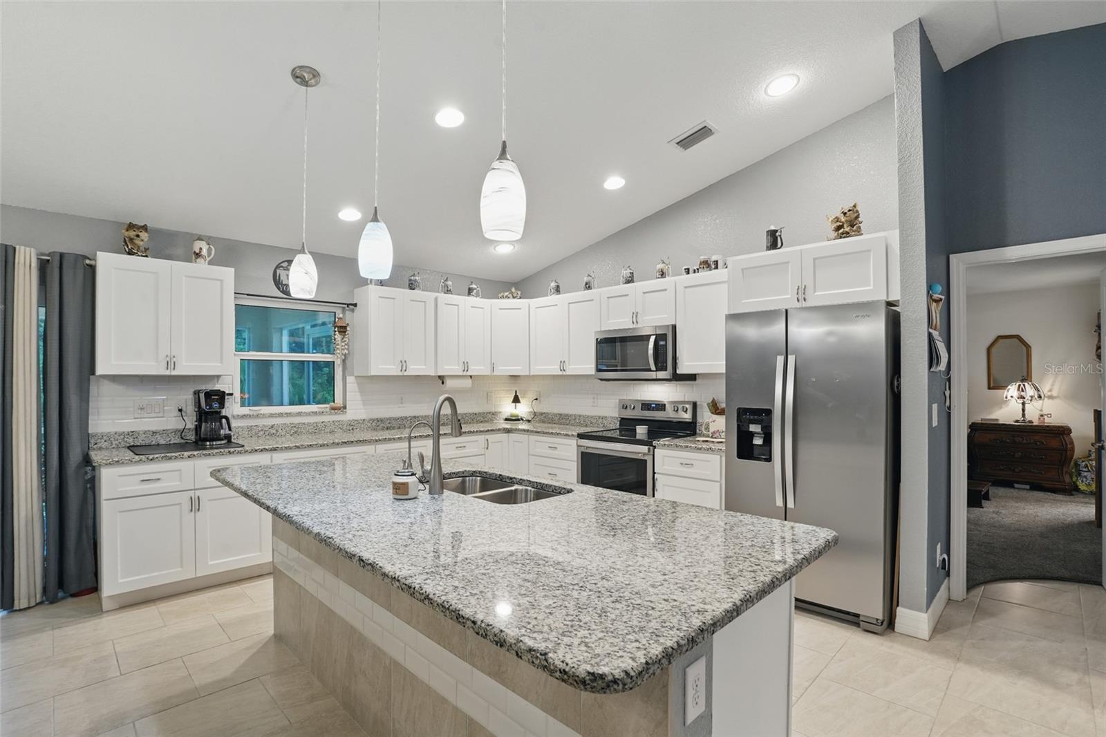Welcome to your dream home! This immaculately maintained 3-bedroom, 2-bathroom gem was built in 2021 and is ideally located on the peaceful edge of North Port—outside the flood zone and completely untouched by recent or past storms, offering both security and peace of mind.
Step inside and be greeted by a bright, open-concept layout with soaring vaulted ceilings and an abundance of natural light. The spacious kitchen is a true centerpiece, boasting stainless steel appliances, an oversized center island with extra storage and seating—perfect for entertaining or everyday living.
The primary suite is your private retreat, featuring a large ensuite bath and generous walk-in closet. A reverse osmosis system adds to the home’s everyday comfort and efficiency.
Enjoy your morning coffee or evening unwind on the screened-in lanai that overlooks a serene, wooded backyard—with plenty of room to build a spacious pool and bring your backyard oasis to life. Whether you're dreaming of weekend barbecues or a tropical retreat, the possibilities are endless.
Additional highlights include:
A brand-new GE washer and dryer combo—included with the home!
A finished garage floor, perfect for a workshop or storing your Florida toys.
A backyard shed with full electrical wiring, ready to become your man cave, she shed, creative studio, or extra storage.
All major systems have been routinely serviced and recently tuned-up, so you can move in with confidence.
Located just minutes from I-75, this home offers quick access to Gulf Coast beaches, golf courses, nature preserves, and kayaking spots—everything Southwest Florida is known for.
Whether you're a growing family or simply looking for a forever home to settle into, this property combines modern living, comfort, and unbeatable location. Don’t miss your chance to own this North Port beauty!