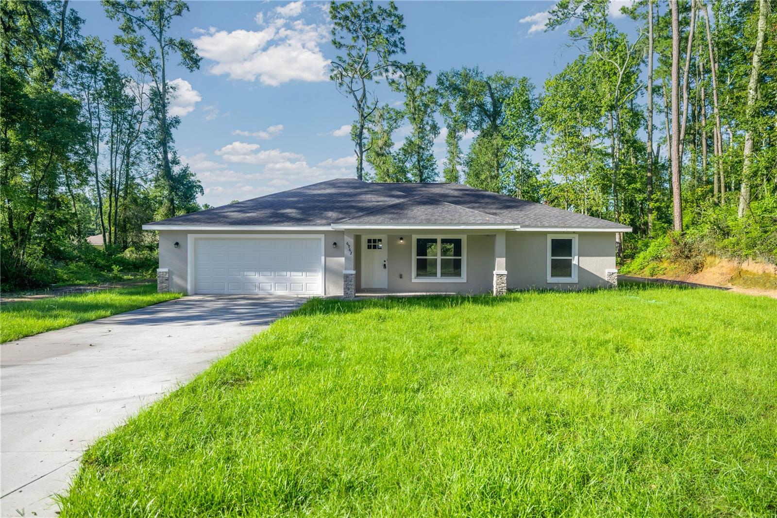 One or more photo(s) has been virtually staged. Welcome to your dream home! This stunning newly constructed residence is ready for immediate occupancy and perfectly situated just outside the charming city of Belleview. Enjoy the ideal balance of peaceful suburban living with unbeatable access to all the shopping, dining, and entertainment options in nearby Ocala and The Villages — all just a short drive away!
Step inside to discover a bright and spacious open floor plan designed for modern living. The home boasts luxury vinyl plank flooring throughout, offering both style and durability. The gourmet kitchen is a true centerpiece, featuring sleek stainless-steel appliances, a generous island, and plenty of space for a large dining table — perfect for family meals or entertaining guests.
The primary suite is your private retreat, complete with a large walk-in closet, featuring a beautiful, tiled shower with glass enclosure.
From the dining area, step through sliding glass doors onto the lanai, where you can relax or entertain while enjoying your backyard oasis. Additional features include an indoor laundry room, spacious 2-car garage, and thoughtful finishes throughout.
Don’t miss this opportunity to own a brand-new, stylish home in a prime location. Call today to schedule your private tour — your new beginning starts here!
CO will be obtained within the next 2 weeks.