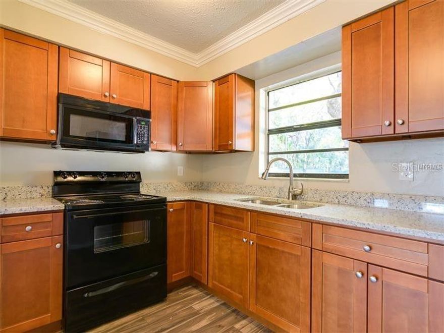 Beautifully renovated 2-bedroom, 1-bath apartment located on the second floor of a charming duplex. Features include shaker kitchen cabinets, granite countertops, updated vanity, new A/C, and a new roof. Laundry closet with washer and dryer hookup, bring your own washer and dryer. Lawn service and water are included in the rent. No pets allowed. Conveniently located near I-275, hospitals, shopping, and entertainment.