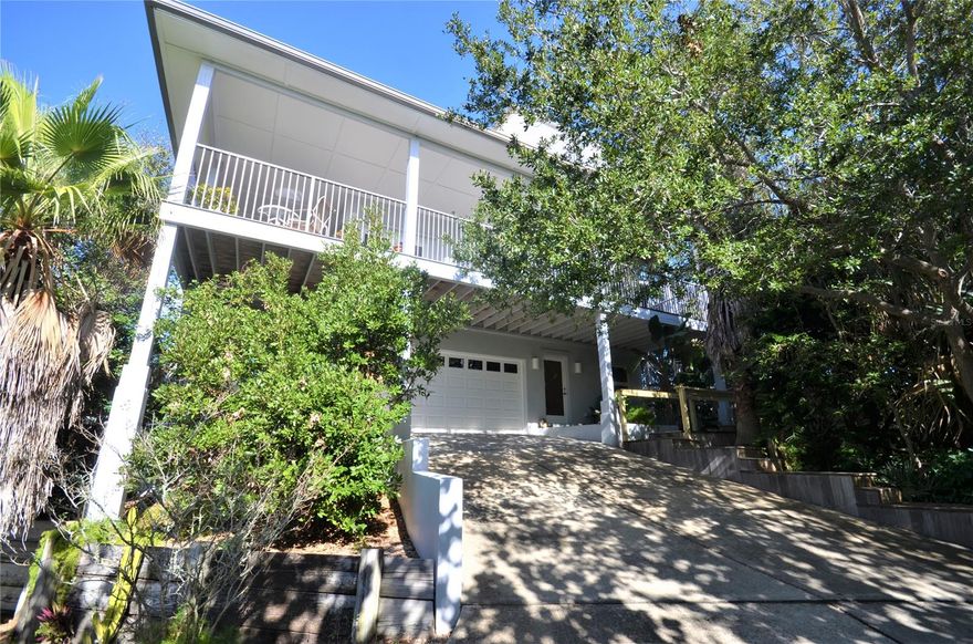 Would you like to live in a truly unique home on North Beach?  This home was designed and built for the current, sole owner.  It is built on top of a high bluff (believed to be the highest point on the island) which affords you spectacular views of the Intracoastal Waterway and the beautiful sandy beaches from the third floor.  Start the tour with the garage on the first floor.  There is also a first floor bedroom and bath with a separate entry.  Ascend to the open, living area on the 2nd floor with lots of natural light and wooden decks all around.  Continue up to the master bedroom on the third floor by way of a wide spiral staircase.  To make life easier, there is a dumbwaiter to transport groceries, etc. from the garage to the second floor.   The grounds are lush and private and require very little maintenance.  There is a fenced area for your pets.  Bring the fishing rods, paddle board, surfboard and bikes.  You're within an easy walk, bike ride or golf cart ride to Flagler Avenue for dining, shopping and local festivities.  Smyrna Dunes Park is even closer, with a fishing pier, walkway and dog beach.    Launch your kayak or SUP from the adjacent easement and you're on the Intracoastal.  And, of course,it's an easy walk to the beautiful sandy beaches for swimming, sunning or sports.  This could be your full-time home or a weekend retreat.  Call for a private showing. ;Water: City