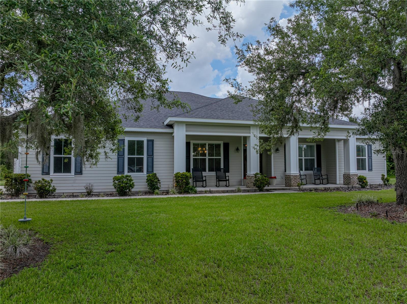 MUST SEE! STUNNING, BEAUTIFUL AND SPACIOUS POOL HOME— Presenting 4 bedrooms, 2 1/2 bathrooms within 2,601 sq ft of living area, while situated on a 5.02 Acre plat of tranquility! This custom home showcases an open floor plan with split bedroom plan, strikingly designed tray ceilings, attractive beamed ceiling accents, crown molding and exceptionally handsome flooring of travertine and wood. Under the unique tray ceiling the open concept incorporates the living room with entertainment center/fireplace combo, and alongside the kitchen island with seating and the eat-in nook. The centrally located kitchen area is accented with ceiling beams that emphasize the cabinetry and granite counter tops; the formal dining room stands between the kitchen and front entry hall. The graceful master bedroom has a duplicate design of tray ceiling w/fan, his/her walk-in closets and a luxury bathroom with glass/tile shower, stylish soaking tub and split vanities. A half bath is convenient to the living areas and the additional full bath has a glass & tile shower with pebble floor, lengthy dual sink vanity and a handy linen closet; this bath is convenient to the additional bedrooms. The laundry room and pantry are positioned by the kitchen. French doors in the living room open to the oversized, screened lanai & pool area that is finished with ceiling fans, brick decking and the pool offers lengthy steps and seating for easy entry, as well as relaxation. The big backyard is fenced in but the surrounding natural Florida landscape offers the opportunity to spot the wildlife happening through the native habitat. There’s plenty of land to erect a barn, garage or to grow a big garden and fruit trees. A private lane from the main road leads to a circular drive and a spacious parking pad at the attached garage of this residence, and the big front porch gives a warm welcome! This peaceful, tranquil property is just a short distance to all necessities, shopping, schools, medical, etc., and easy access to SR-Hwy 60, a great Central Florida location! Call to Schedule a Viewing Today!