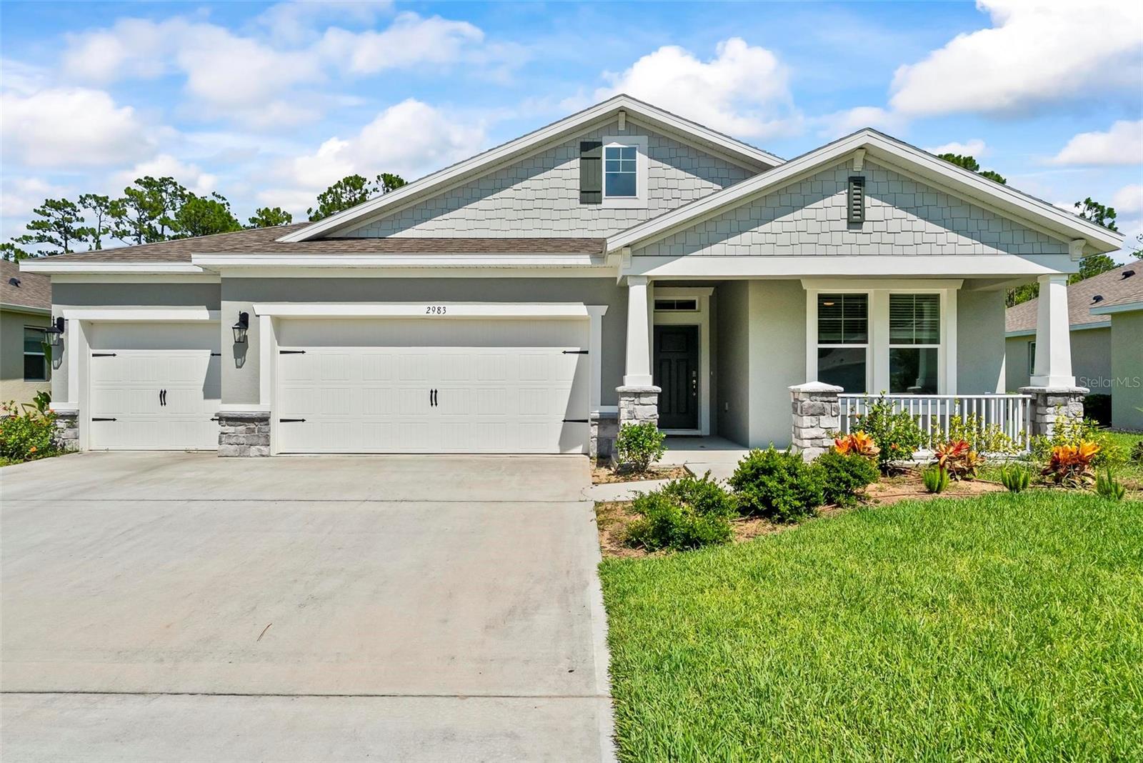 Better Than New – Modern Elegance with Premium Upgrades in Halifax Plantation. Welcome to 2983 Monaghan Drive, a beautifully upgraded Robinson model built in 2023 that blends modern design, smart-home features, and exceptional comfort. Located in the highly desirable Halifax Plantation Golf Course Community, this 4 bedroom, 3 bathroom home offers 2,106 square feet of thoughtfully designed living space, along with a spacious 3 car garage. Set on a premium preserve lot, the professionally landscaped exterior creates a striking first impression and offers peaceful, private views. Inside, a wide formal foyer leads into an open, split floor plan with tile flooring throughout the main living areas, 9 foot ceilings, and 8 foot six-panel doors. The kitchen is the heart of the home, featuring quartz countertops, a tile backsplash, solid wood cabinetry, stainless steel appliances with a sleek vent hood, a walk-in pantry, and a large center island. A cozy dining area completes the space, offering the perfect flow for everyday living and entertaining. This home has been thoughtfully enhanced throughout. Under-cabinet lighting brightens the kitchen workspace, while 4 inch recessed wafer lighting and accent lighting on the front exterior create a warm, modern ambiance. Smart switches throughout the home offer added convenience. Ceiling fans were installed in all bedrooms, the living room, and the outdoor patio for year-round comfort. A wood accent wall in the living room and another on the kitchen island add visual interest and character. The hallway features elegant chair rail molding with custom paint finishes. The back patio is fully covered and pre-wired for a television, making it ideal for relaxing or entertaining outdoors. A 50 amp generator hookup adds extra peace of mind. The spacious owner’s suite overlooks the tranquil preserve and includes a tray ceiling, an oversized walk-in closet, and a luxurious ensuite bath complete with a soaking tub, fully tiled shower, dual vanities, and a private water closet. Secondary bedrooms are generously sized with plush carpeting, offering privacy and comfort for guests or family. Halifax Plantation offers a lifestyle of leisure and recreation with an 18-hole championship golf course designed by Bill Amick, a 25,000 sq ft clubhouse featuring The Pub Sports Bar and Tavern by the Green restaurant, four clay tennis courts, a fitness center, pro shop, and a community pool. Ideally located near I-95 and just minutes from shopping, dining, and the beach via the scenic loop through Tomoka State Park, this home offers the best of both convenience and serenity. This isn’t just move-in ready—it’s better than new, with thoughtful upgrades and timeless style throughout. *All information recorded in the MLS is intended to be accurate but cannot be guaranteed.