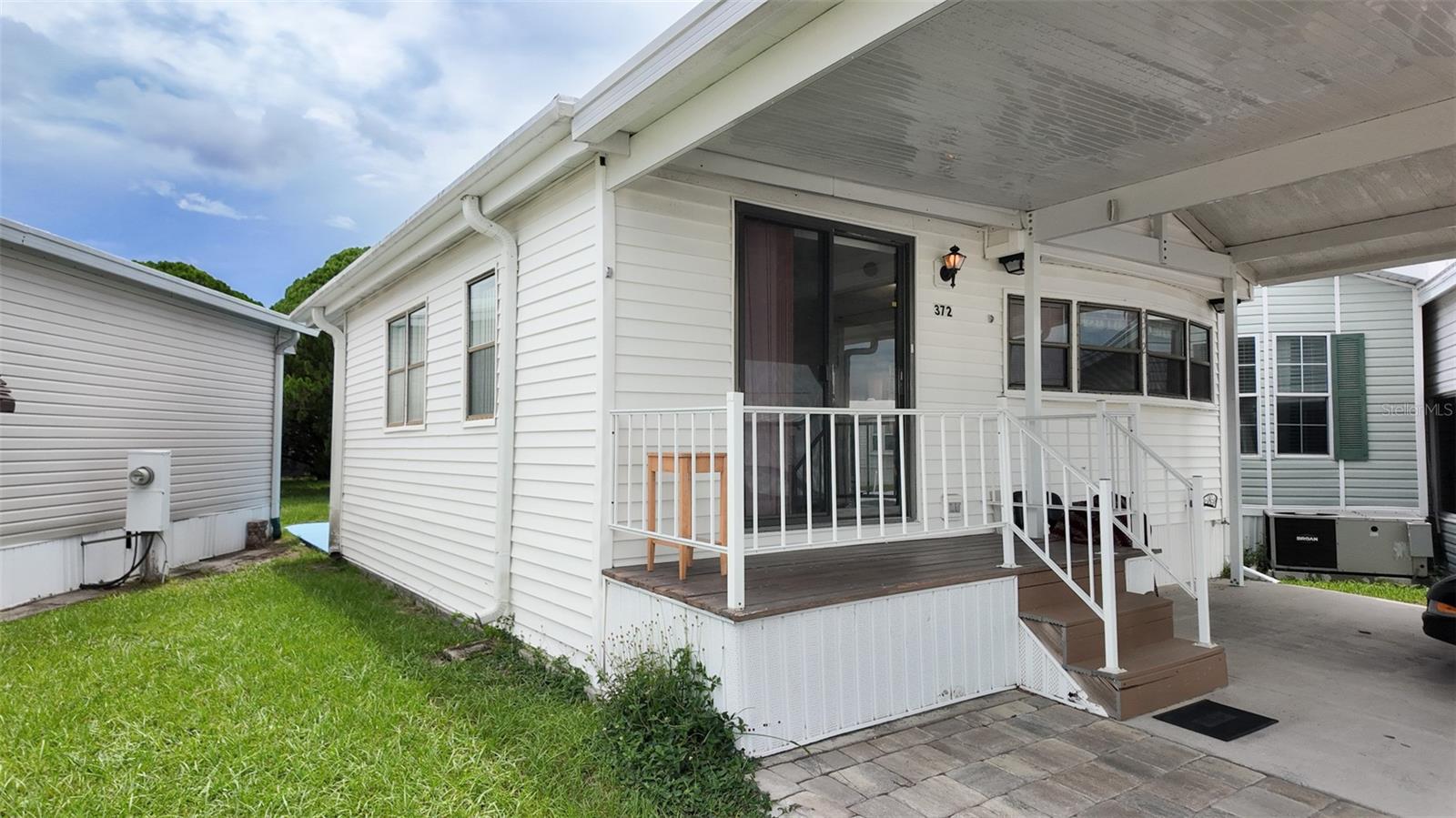 Welcome to this charming 1 bedroom, 1 bathroom home located in the sought after 55+ community of Outdoor Resorts of Orlando. This cozy, well maintained manufactured home offers the perfect blend of comfort and convenience for retirees or snowbirds looking to enjoy Florida's sunshine. The open concept layout features a spacious living area that flows into the kitchen. The kitchen is fully equipped, and the bedroom offers a peaceful retreat with enough room for a queen sized bed The full bathroom provide everything you need for comfort and functionality. Enjoy peace of mind with covered parking, keeping our vehicle protected from the Florida sun and rain. Step outside to your personal patio space and enjoy the vibrant atmosphere of this active adult community.