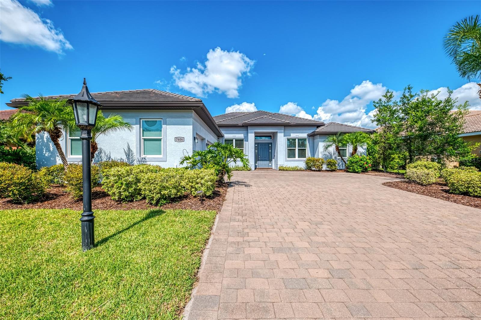 THIS IS THE ONE! This executive home offers over 3,000 square feet of beautifully designed living space in the gated community of Trillium, just minutes from world-class beaches including Siesta Key, UTC shopping and dining, and zoned for TOP A RATED elementary, middle, and high schools. Completed in 2015 as one of the last homes built in the neighborhood, it offers the charm of an established community with the comfort of newer construction. Nestled within an exclusive enclave of just 72 homes, this home is surrounded by lush, well-kept landscaping, and winding sidewalks perfect for evening strolls, all with a surprisingly low HOA and no CDD. Designed with flexibility in mind, the layout includes 3 bedrooms, 3 full baths, a dedicated home office, and a bonus or media room that can be configured as a 4th bedroom if desired. Curb appeal starts with an oversized paver driveway leading to a 3-car garage finished with easy-care Spartacote Polyaspartic flooring. Peace of mind comes with hurricane-impact windows and doors, plus a generator plug near the electrical panel. The exterior A/C unit was replaced in 2023 for improved efficiency, and the home features a four-zone system for enhanced comfort. Inside, soaring double tray ceilings with crown molding create an elegant atmosphere. Engineered hardwood flooring flows throughout the main living areas, with plush carpet in the bedrooms and tile in the bathrooms. The baths are appointed with the same maple shaker-style cabinetry as the kitchen, paired with their own quartz countertops for a refined, cohesive design. Impressive 8-foot doors and a thoughtfully placed laundry room away from the garage entry add both style and function. The kitchen showcases shaker-style maple cabinetry, quartz countertops, a reverse osmosis system, and an oversized stainless steel side by side refrigerator and freezer, complemented by other stainless appliances installed in recent years. California Closets enhance storage in both the pantry and primary suite, while a central vacuum system adds everyday ease. Outdoors, the screened paver lanai offers a perfect spot to unwind with peaceful lake views and colorful sunsets. A fenced backyard provides space for pets or outdoor enjoyment while preserving open water vistas. This home is move-in ready and located in one of Sarasota’s most desirable areas. Schedule your private showing today!