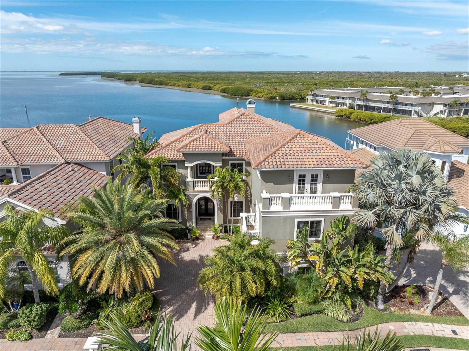 Welcome to 4118 Causeway Vista Drive, a magnificent waterfront estate located in the gated community of The Reserve of Old Tampa Bay. This luxurious property offers an unparalleled combination of elegance, comfort, and stunning bay views, making it a true haven for those seeking the g. Walking up the steps to the commanding front doors you realize this home is truly a sanctuary combining luxury,
relaxation, and entertainment. Once inside you’re drawn to the formal living room that captures stunning bay views. These views continue
through the family room that has a beautiful wood tray ceiling, custom built-in cabinetry, and cozy gas fireplace, creating a warm and inviting ambiance. The tray ceiling extends into the Tuscan designed kitchen equipped with a six-burner gas cooktop with custom hood, built-in oven, matching cabinet-faced refrigerator, butler’s pantry with bar refrigerator, large island with prep sink, walk in pantry, and a spacious dining area. Those special dinners will be celebrated in the formal dining room that exudes elegance with the copper ceiling and stunning chandelier. The first level also offers a study that showcases beautiful built-in bookshelves and tin ceiling, creating an inviting atmosphere for work or leisure. The second level begins as you make your way up the amazing staircase enhanced with iron spindles. Here you’ll find the primary suite. This private retreat uniquely features two levels with panoramic bay views. The large ensuite entails a walk-in shower, jetted soaking tub, and double vanities. Additionally, it offers two walk-in closets with custom shelving, sitting area, gas fireplace, and an office in the crow's nest with a balcony, where you’ll encounter amazing sunsets. Each of the other bedrooms in the residence are thoughtfully designed and offers its own unique features. The fifth bedroom is a very private space and currently used as a gym. It would make the perfect guest room or in-law suite. There’s also a massage room with a balcony perfect for unwinding after a long day at work, which could also be used as a second office space if needed. For those who appreciate the magic of cinema, the theatre room located on the third level has elevated seating and is ideal for hosting movie nights and creating unforgettable experiences. This large room has beautiful built-in cabinetry and a billiards table for an added bonus. The expansive pool area is one of many highlights this home captures for your outdoor enjoyment. It’s the epitome of outdoor living. Spend your days basking in the Florida sunshine or cool off with a refreshing swim while enjoying the tranquil waterfront backdrop. The outdoor kitchen is equipped with everything you need for hosting memorable gatherings and dining under the stars. Water enthusiasts will rejoice in the presence
of not one, but two boat lifts, offering convenient access to the bay and making it effortless to embark on boating adventures. Explore the
beautiful Tampa Bay area, go fishing, or simply enjoy a leisurely cruise along the scenic coastline. The possibilities are endless for those who appreciate the allure of waterfront living. Don't miss the opportunity to make this waterfront retreat yours. Contact us today to schedule a private viewing and experience the exceptional waterfront lifestyle that awaits you at 4118 Causeway Vista Drive.