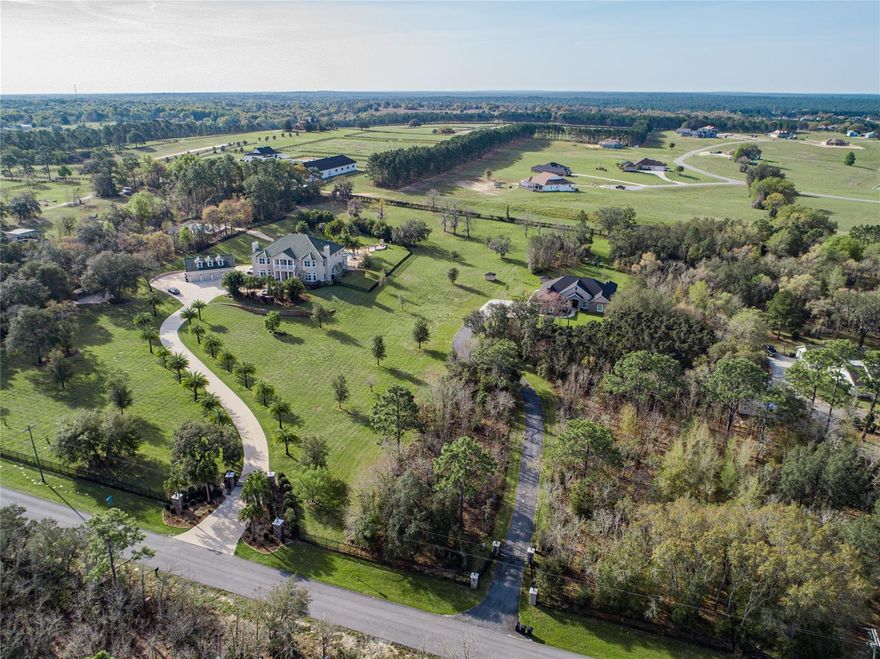 Celebrity style "CRIB" featuring 2 separate homes with a unique atmosphere to entertain, store exotic toys, or just relax with a breathtaking resort style pool deck, lanai and outdoor kitchen. Equipped with separate basketball and volleyball courts, two story gym and yoga room (equipment included), tons of garage/storage space, and even room for animals. On almost 11 acres fully rod iron and stone pillar fencing with 2 separate elaborately landscaped electric entrances this property is one of a kind and one worth seeing! Main house is a 2 story 5 bedroom, 6 full bath, 1 half bath and extra downstairs office with 4 car detached garage with a finished upstairs room. Second home is a 1 story 4 bedroom, 3 bath and office with 3 car attached garage. Behind the second home is a 2 story 3000sf fully equipped gym downstairs with 1/2 bath and finished mirrored wall yoga room upstairs. There are a few dog kennels on the property as well as a small barn of sorts in a wooded fenced parcel for animals. No HOA and NOT deed restricted! All information is deemed accurate but not guaranteed. ;Water: City