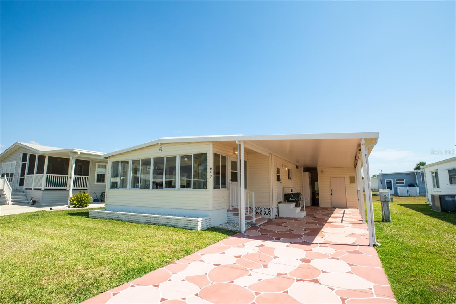 CHARMING FURNISHED 2 Bedroom, 2 Bathroom, Carport manufactured home located in the active 55+ Harbor Cove Community. CLICK ON THE VIRTUAL TOUR LINK 1 FOR THE VIDEO AND VIRTUAL LINK 2 FOR THE 3D TOUR. Spend quality time with friends and family in the open living room while whipping up family favorites in the kitchen. The EAT-IN kitchen offers all-white appliances, ample counter space, and a closet pantry. The master bedroom has an oversized built-in closet and a private bathroom with a single sink vanity and a walk-in shower. The guest room has a built-in closet and a guest bathroom nearby. Expand your living and entertaining space to the Florida room, where you can sip your morning coffee or unwind with your favorite evening beverage while enjoying the BEAUTIFUL Florida weather. There is a storage room for extra storage space and it doubles as a laundry room. HURRICANE RATED CARPORT - HURRICANE SHUTTERS. Harbor Cove is an active resident-owned WATERFRONT community with a clubhouse, two community pools, an exercise gym, shuffleboard & bocce ball courts, a private marina, a wood workshop with lots of craft activities and classes, and TONS of resident social events to keep you active year-round! Conveniently located near US 41 for easy access to local shopping, dining, LIVE entertainment, and award-winning beaches. Schedule your private showing TODAY!